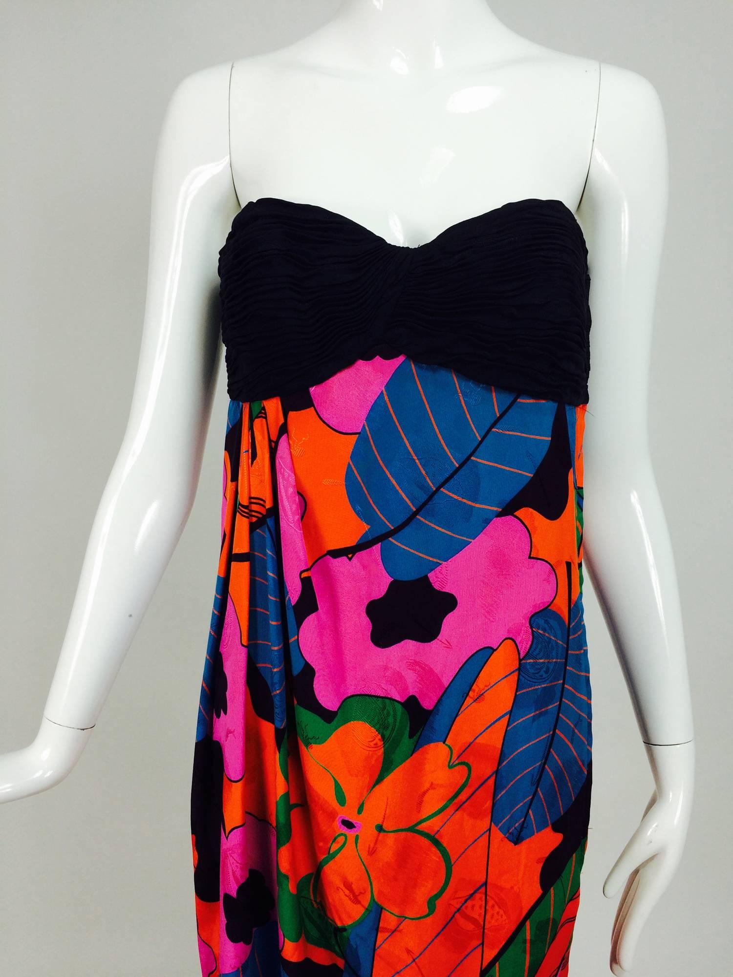 Emanuel Ungaro Parallele tropical print strapless maxi dress 1970s. Strapless black figured silk bodice is pleated and shaped at the front bust, interior corset. The figured silk of the skirt is in vibrant shades with a very tropical feel. The skirt