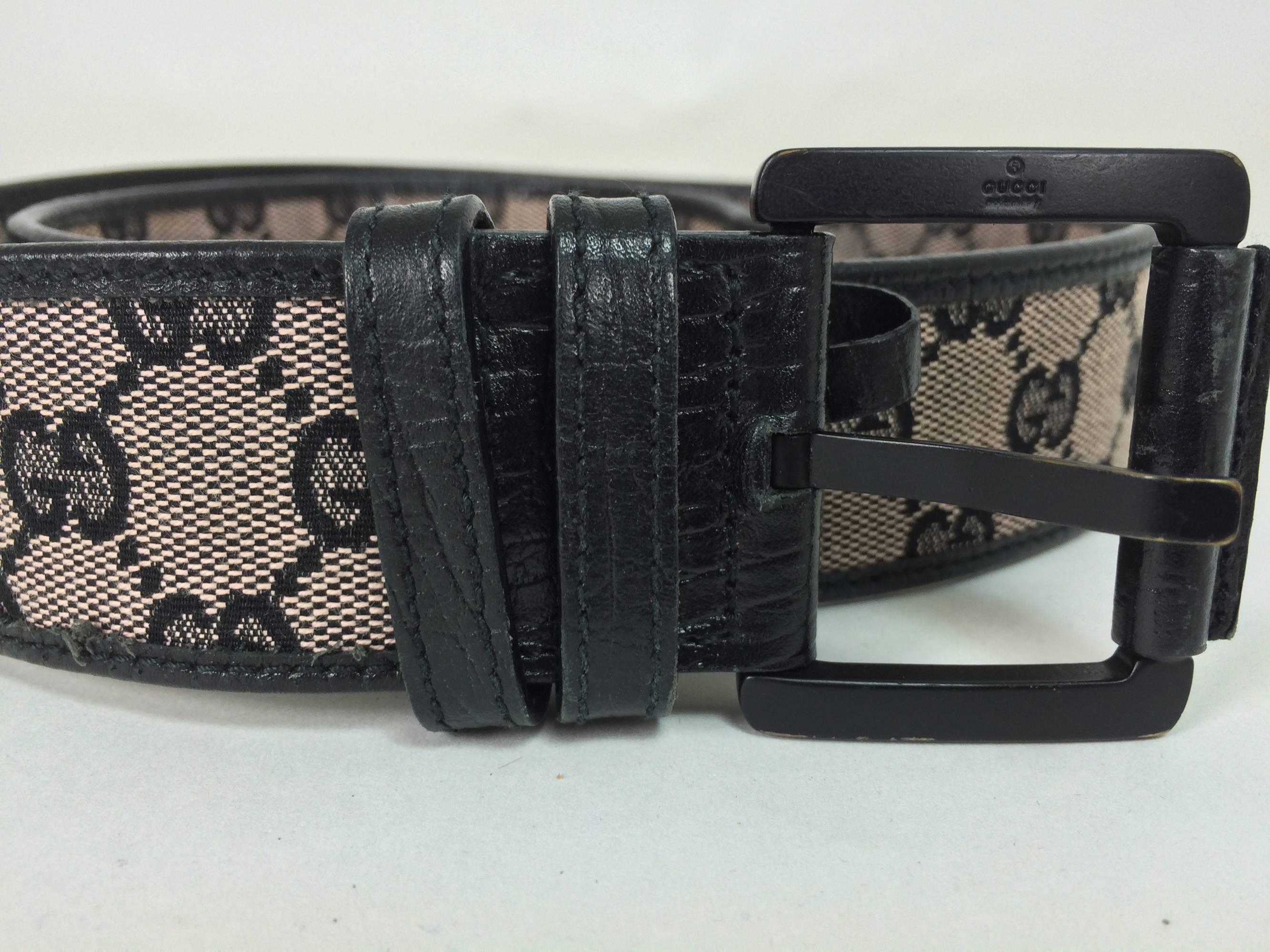 Gucci black wide logo canvas & leather belt M...Logo canvas is leather trimmed, with a metal buckle (leather trimmed). A very light loss of colour to the bottom edge of the buckle, otherwise excellent.
Measurements are:
40