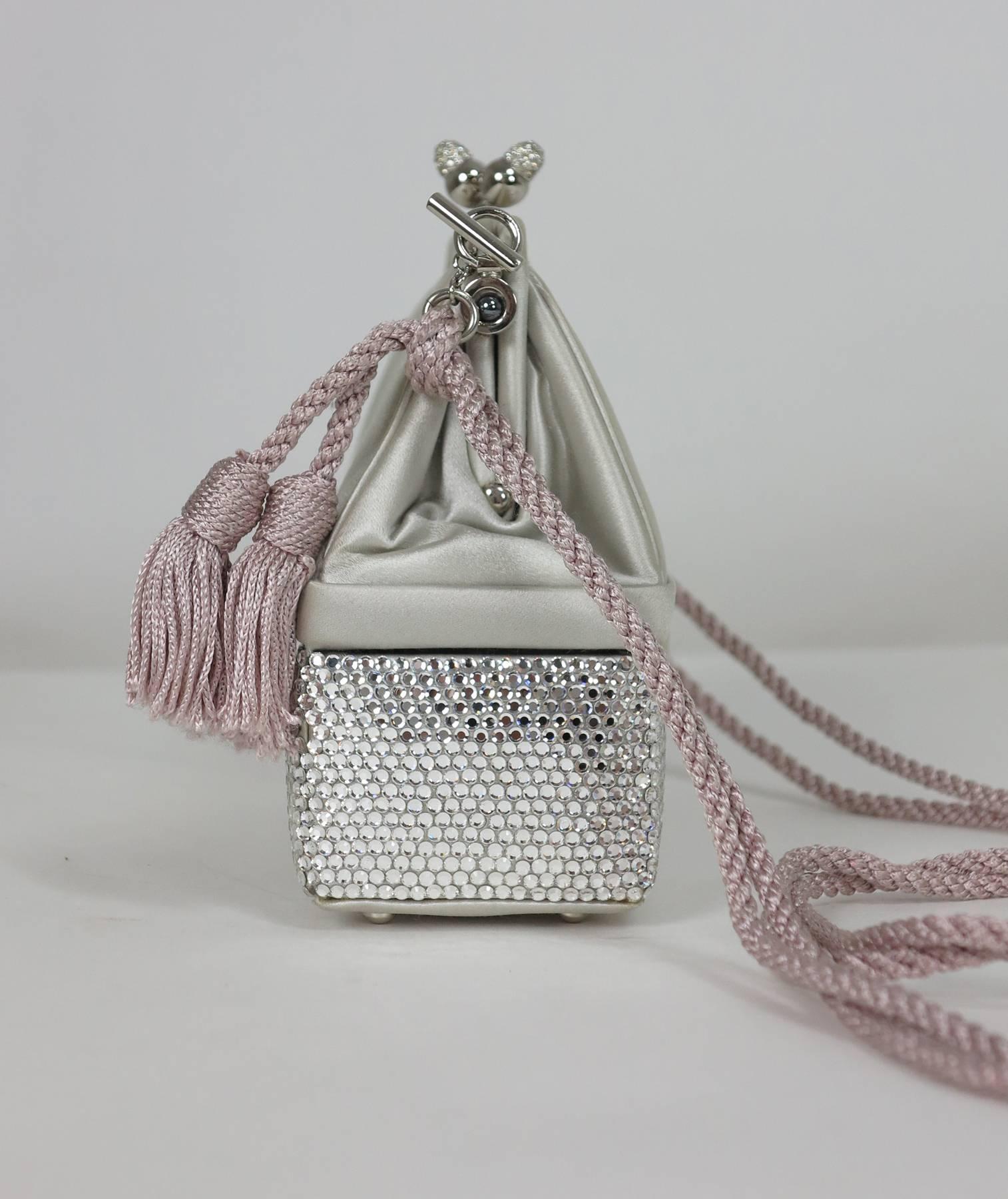 Judith Leiber silver satin & Swarovski crystal two tier minaudiere evening bag...
Silver grey satin upper frame bag with silver set with crystal rhinestones in the clasp, the lower part of the bag is covered with Swarovski crystals, opens at the