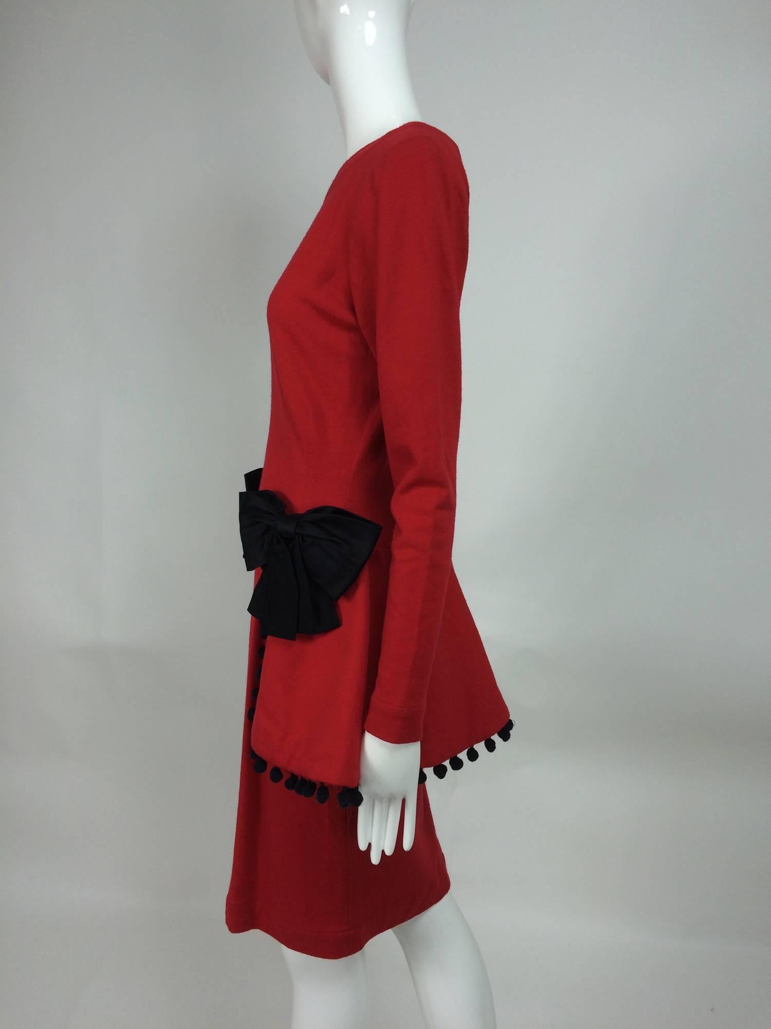 Isabelle Allard Paris red jersey dress with peplum hip bows & pom poms 1990s...Fine red wool jersey dress with darted waist and a banded jewel neckline...Long tapered sleeves...Peplum waist (actually sits just below the natural waist line) with