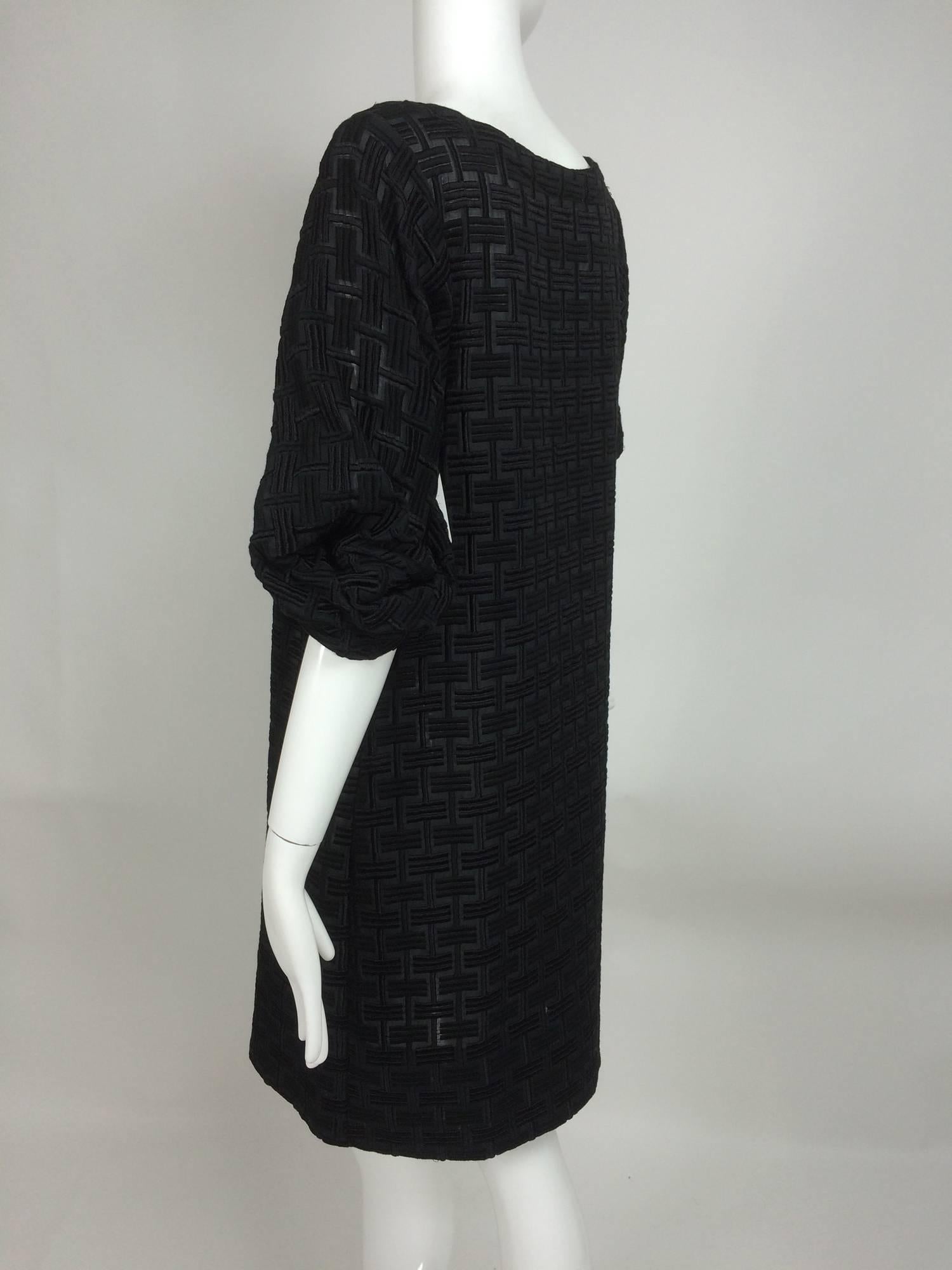 Marni heavily embroidered sheer black cotton day dress...Scoop neck dress with full sleeves that are gathered at the elbow and drape at the sleeve back...A line shape dress is heavily embroidered in a grid pattern in alternating black shades (very