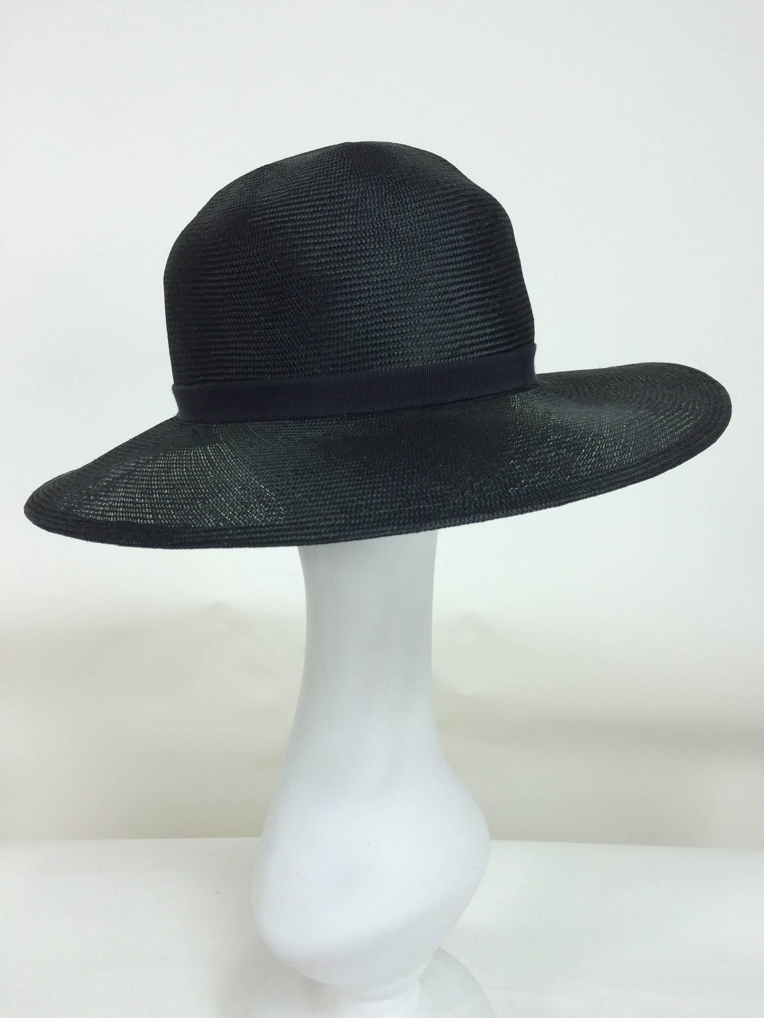 Vintage Galanos fine woven black straw fedora hat 1960s...Light weight open weave fine quality straw in black...Shaped crown with black gros grain band...Wired brim edge...Wide gros grain band inside...In excellent condition...

Measurements