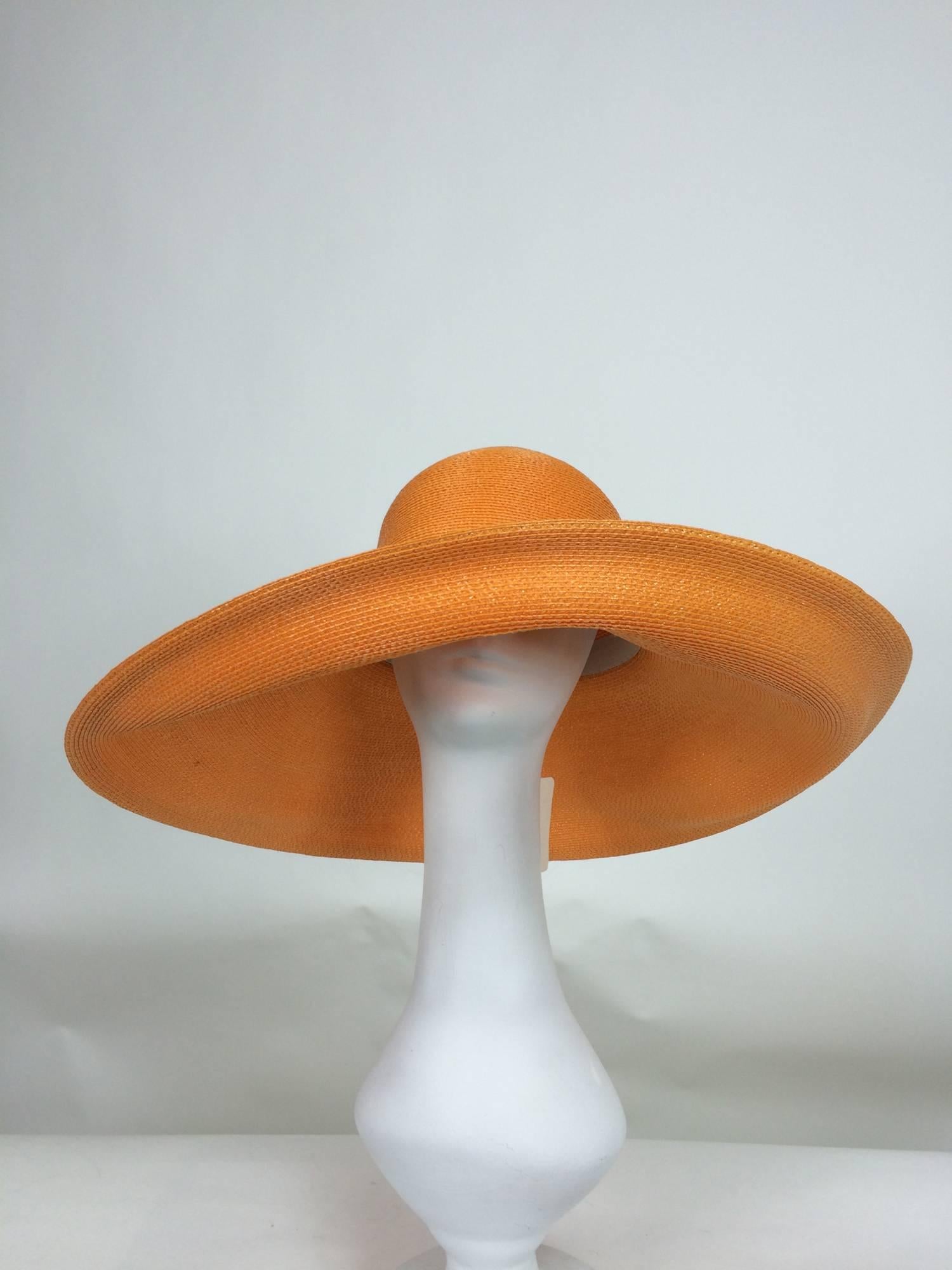  Vintage Galanos orange glazed straw wide brim hat 1960s unworn...Super wide brim hat has a deep crown, inside gros grain ribbon band...Brim can be worn turned back or down...Fine quality straw...
Measurements:
22