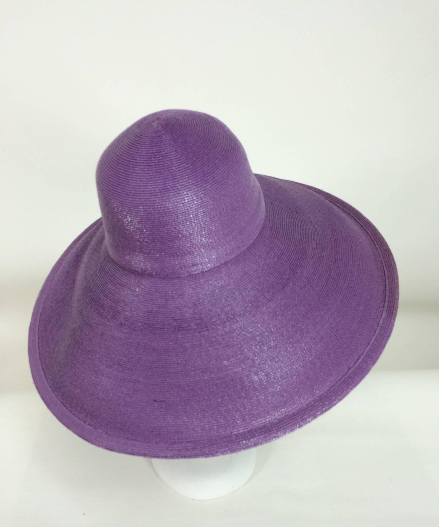  Vintage Galanos purple glazed straw wide brim hat 1960s unworn...Super wide brim hat has a deep crown, inside gros grain ribbon band...Brim can be worn turned back or down...Fine quality straw...
Measurements:
22