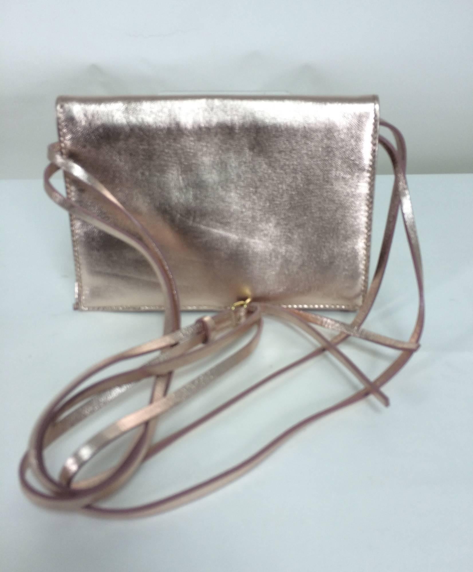 Vintage Baccarat Eclipse pale pink metallic leather with crystal shoulder bag...New in the box...This bag can be worn as a shoulder bag or carried as a clutch...Multi strand metallic leather shoulder strap has a gold adjustable buckle...Fold over