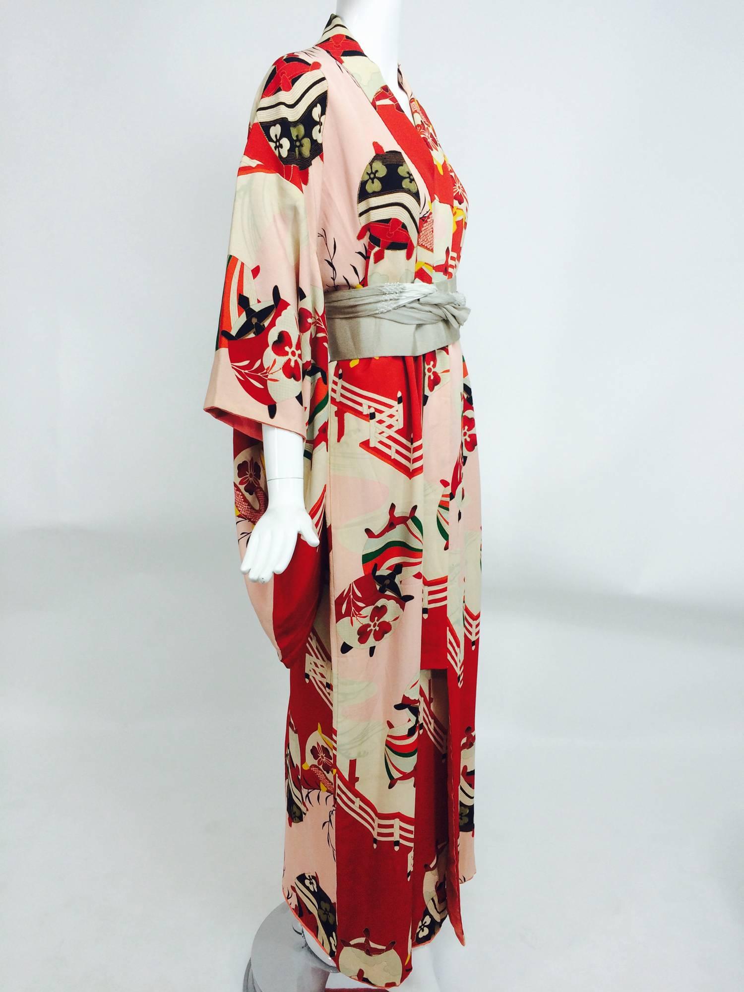 Pre WWII red and pink silk crepe Japanese Kimono 1930s...The print of this kimono is beautiful with bright red and pale pink, the design of lanterns and rails some highlighted with gold...Lined in bright red tissue silk and salmon pink crepe...With