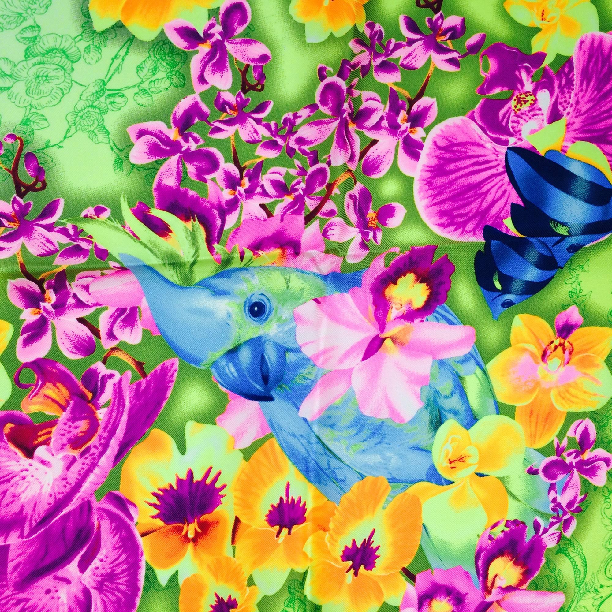 Versace DV Donatella Versace orchid & sea life silk scarf...The center of the scarf is done in a green and white line drawing of Donatella Versace surrounded by cherubs, the outer border is neon yellow-green with brightly coloured orchids & tropical