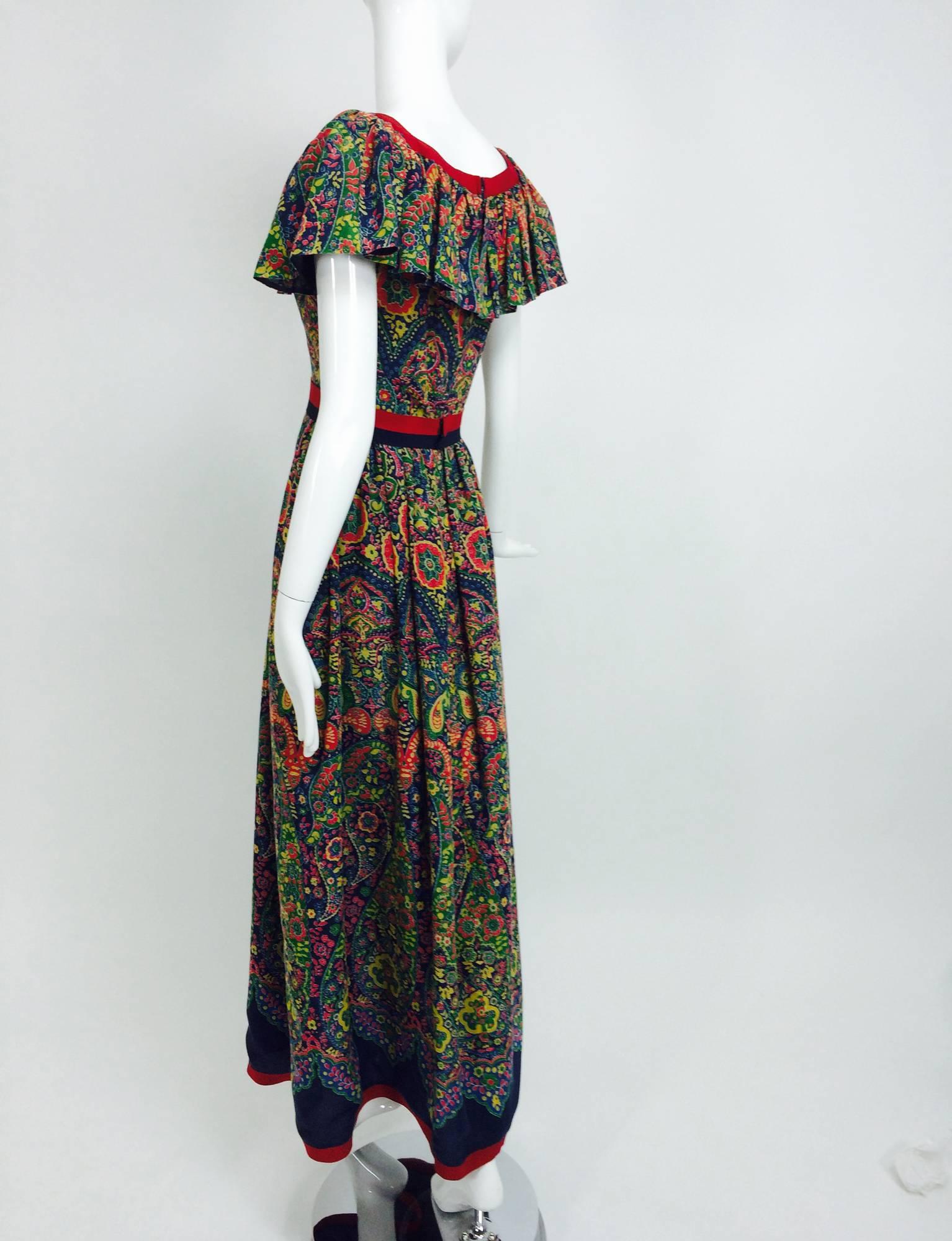 Vintage Mollie Parnis floral gauze ruffle shoulder maxi dress 1960s...Floral & paisley printed gauzy fabric in dark blue, coral, yellow and green with a sleeveless fitted bodice wide square neckline trimmed in blue & red gros grain ribbon and deep