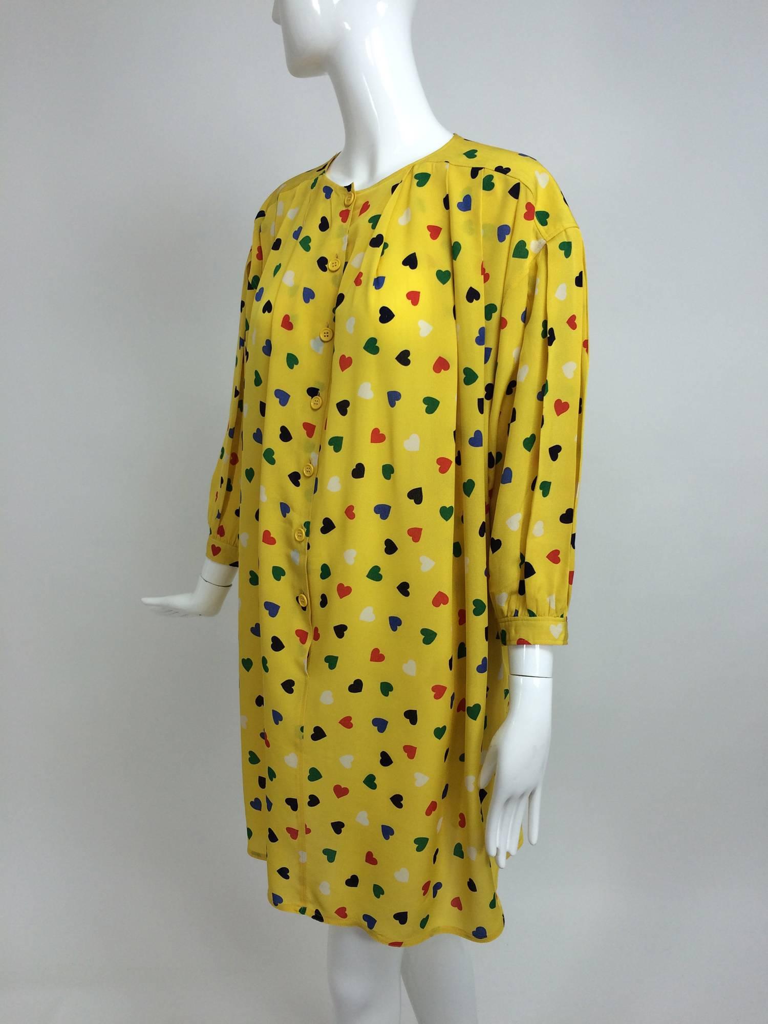 Vintage Ungaro coloured heart print yellow smock dress 1980s...Yellow rayon crepe smock dress is printed all over with hearts in red, blue, green and black...The dress has a round yoke neckline, dropped shoulder, button placket front and falls in