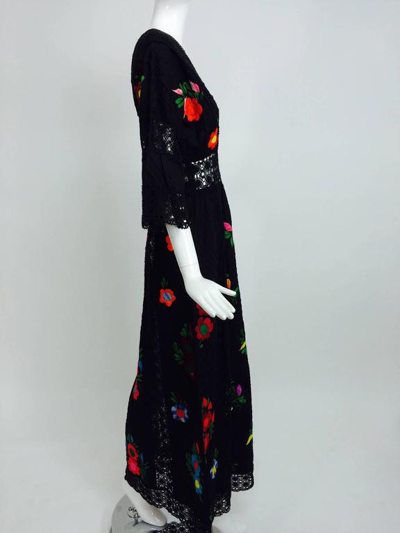 Vintage colourfully embroidered black cotton and lace Mexican maxi dress 1970s For Sale at