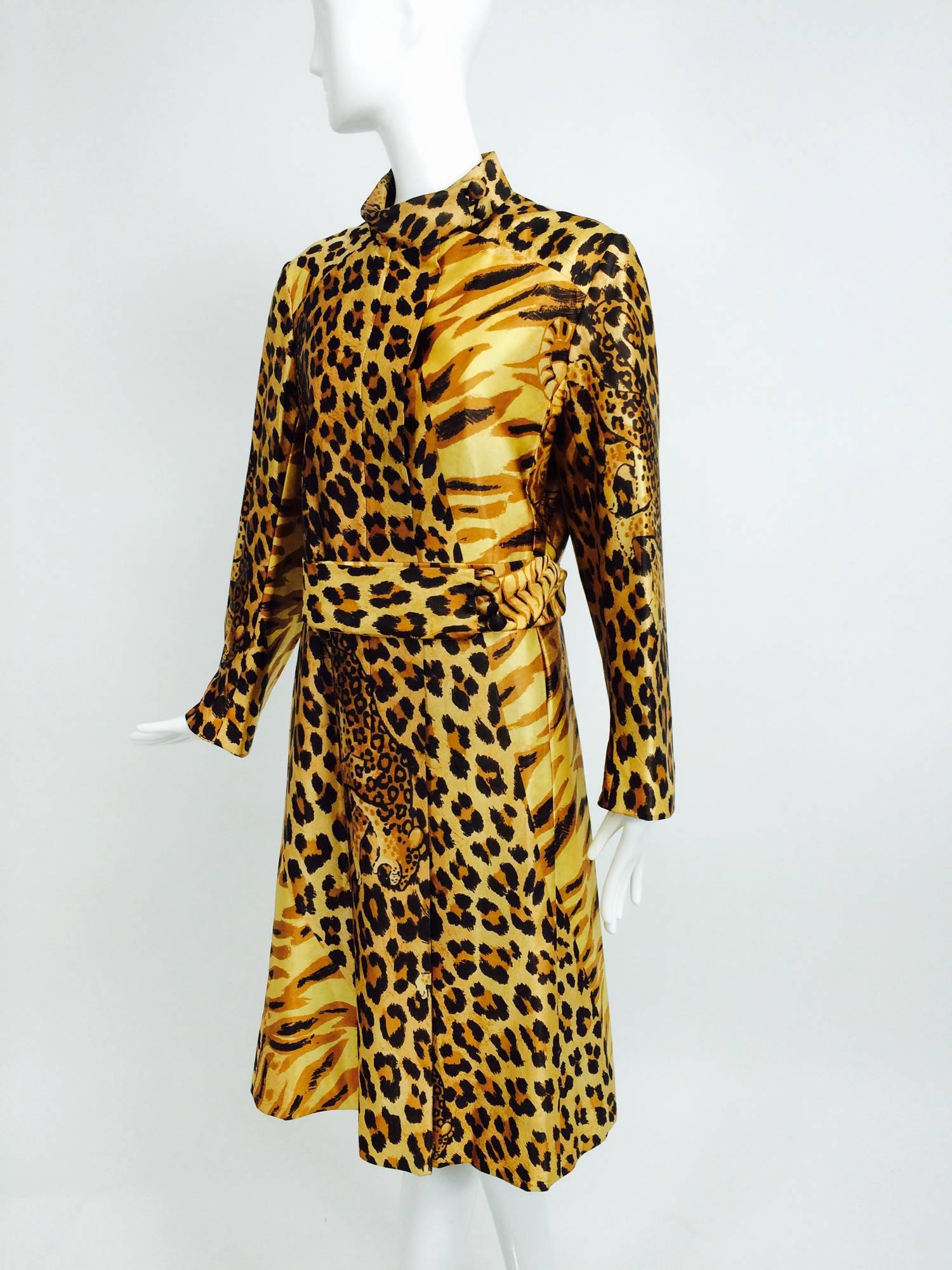 Fantastic leopard print, with prowling leopards! Rain coat from the 1970s labeled Main Street has a stand up collar with covered button closure at the neck...Single breasted placket front coat with on seam front pockets and self belt...Shoulder yoke
