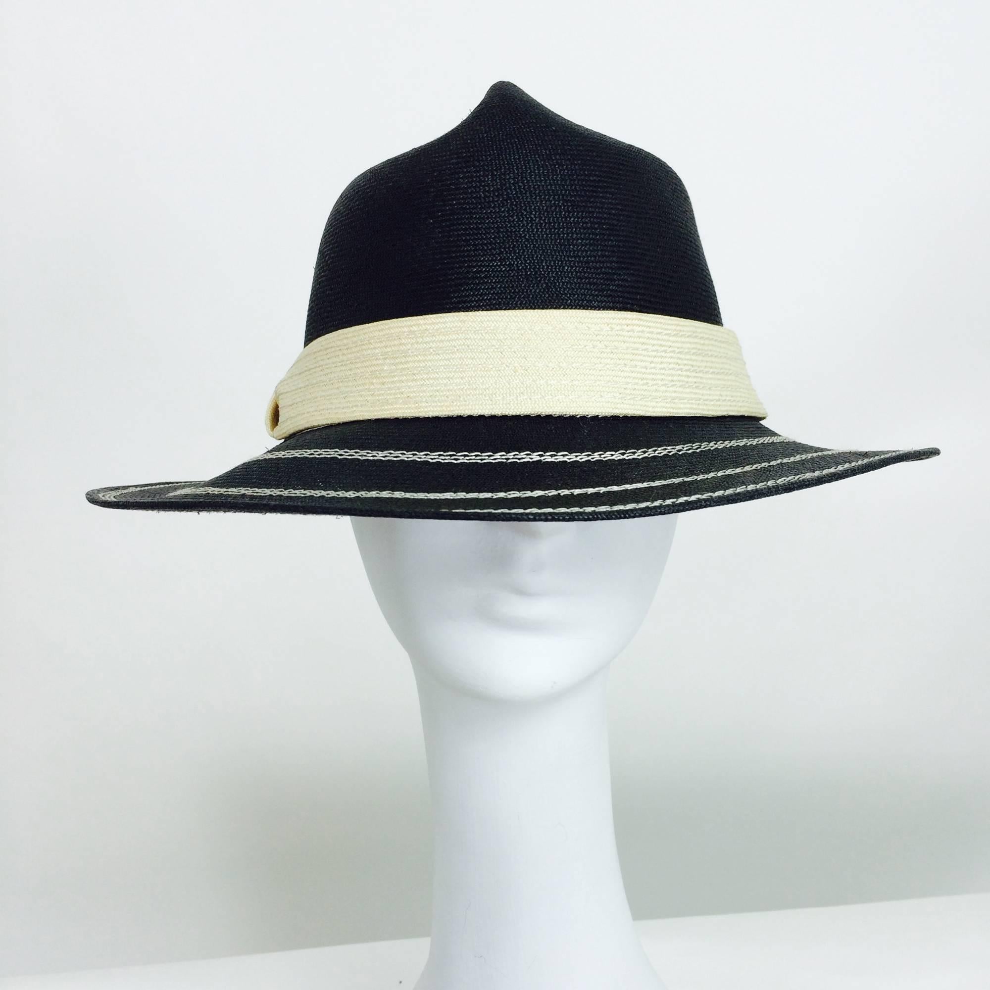 James Galanos black & ivory straw fedora style hat from the 1960s...Unworn with the original inventory tag...Black straw hat with ivory decorative stitching around the brim...Ivory straw wide band....The crown of the hat is shaped...In excellent