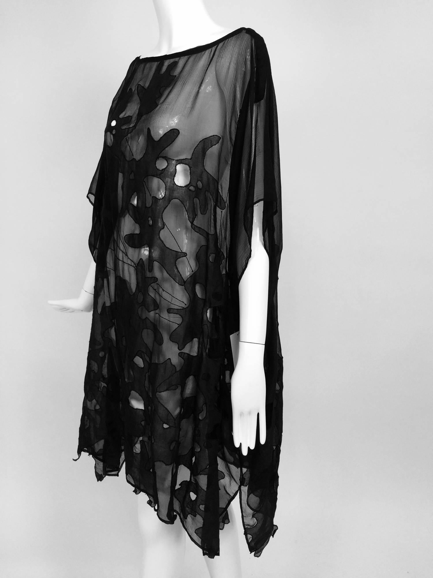 Dries Van Noten black silk chiffon applique and cut out caftan tunic...Uniquely designed with abstract appliques and open cut outs...The hem is done in irregular pieces of fabric...One Size...

In excellent wearable condition... All our clothing