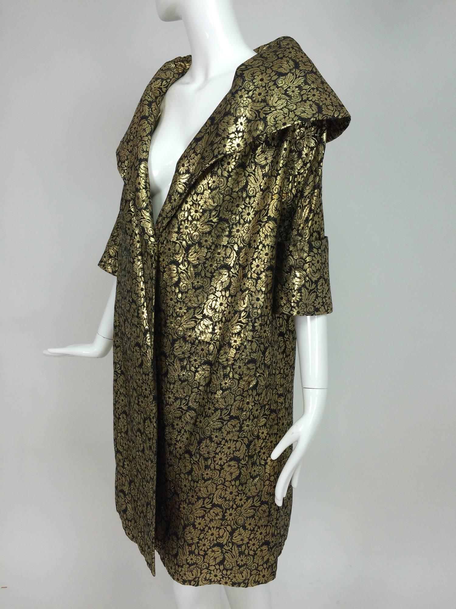 Vintage gold brocade shawl collar evening coat 1950s...This beautiful coat features a deep shawl collar that can be worn up, to frame your face...3/4 length deep cuff raglan sleeves...side front banded pockets...the back has a long inverted pleat