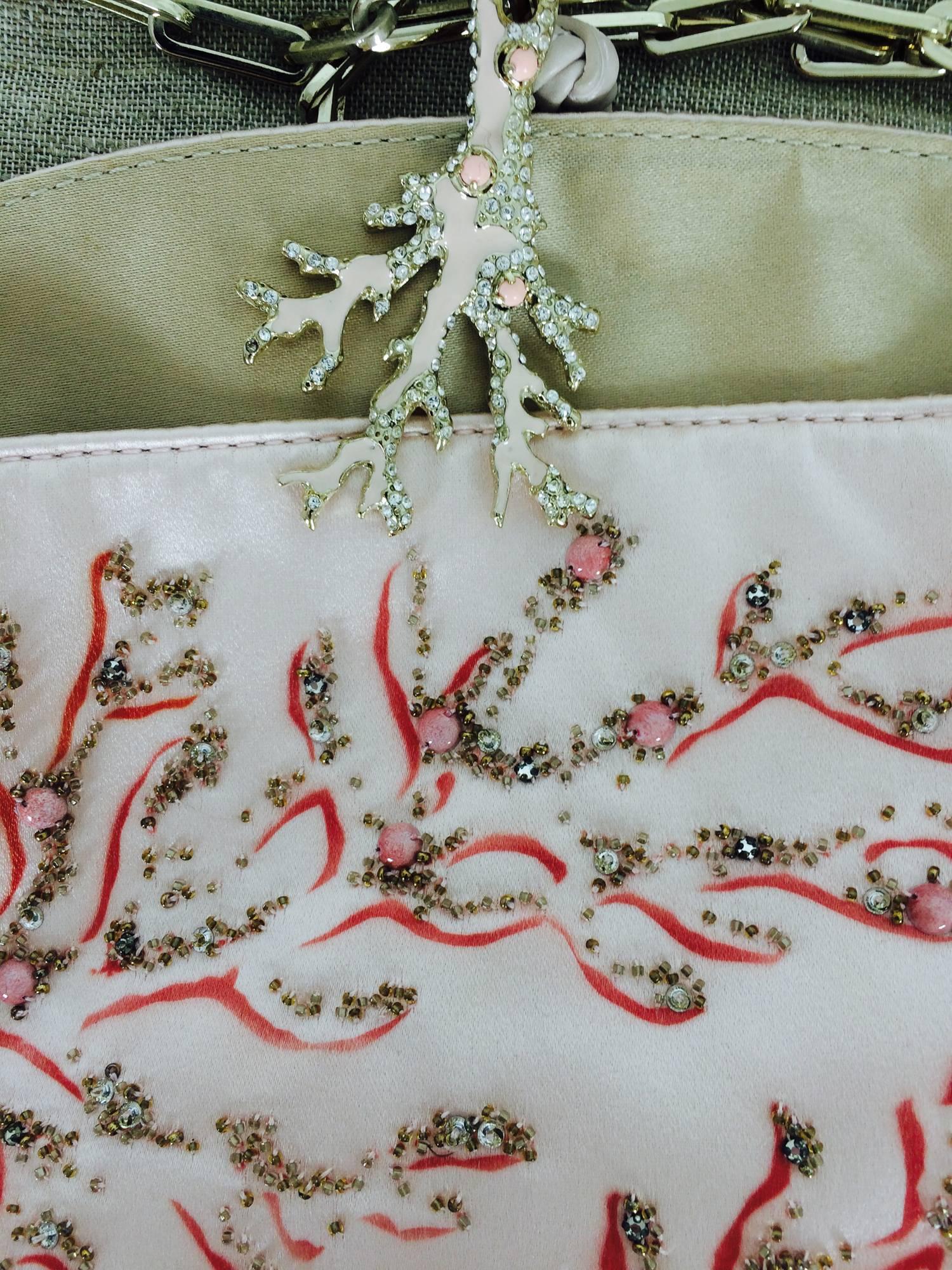 Valentino Garavani hand painted and beaded coral jewel evening bag...Pale pink silk satin bag is decorated at the front in a coral design done in crystal beads and coral beads, with hand painting...The bottom of the bag is gold leather...Lined in