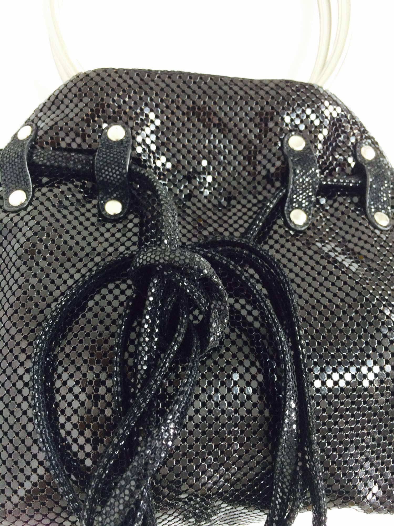 Whiting & Davis black metal mesh handbag with silver ring handles...Great bag has silver studs and suede ties to adjust bag...Closes with a hidden magnetic closure...Fully lined in logo satin...Looks barely, if ever used...
Measurements