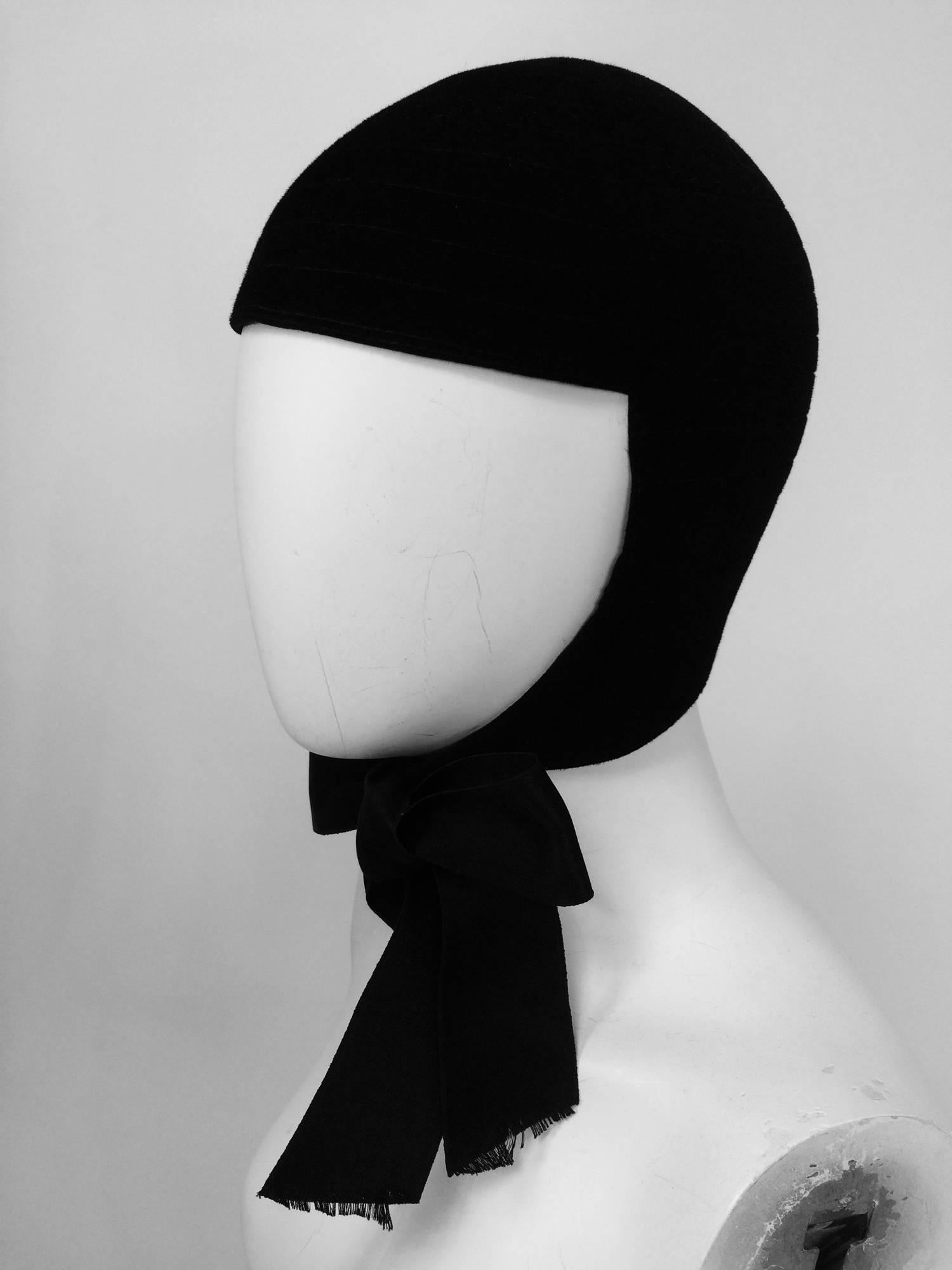James Galanos black velvet Mod black velvet felt helmet hat 1960s...All the rage in the space addicted 60s, the helmet...James Galanos' version in black velvet felt with decorative top stitching throughout, the hat fits close to the head and ties at