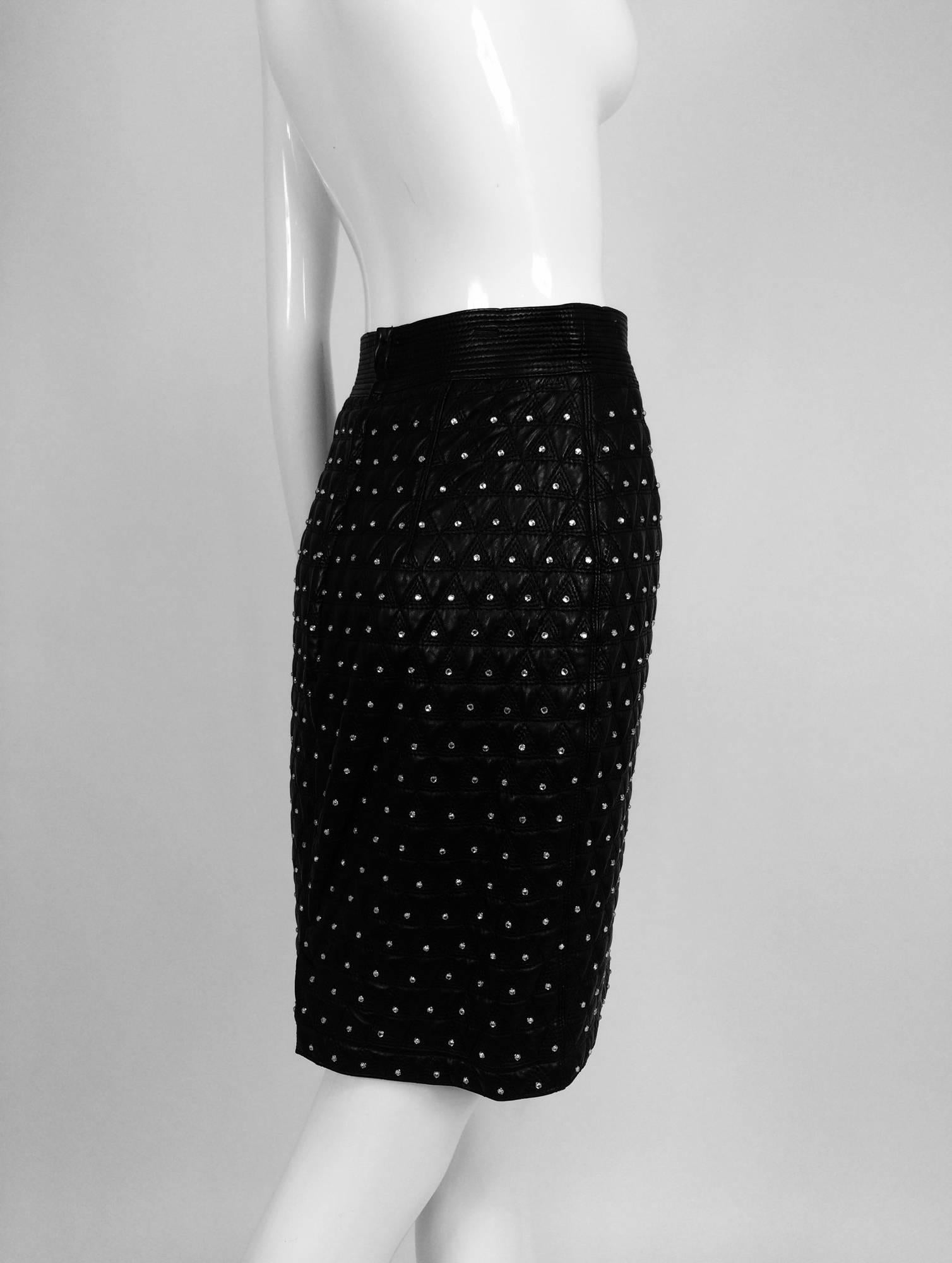 Gianni Versace Quilted black leather & rhinestone skirt 1980s...High waist skirt has a horizontal band of plain black leather, the skirt is diamond quilted each center set with a crystal rhinestone...Fully lined in black rayon...2 1/2