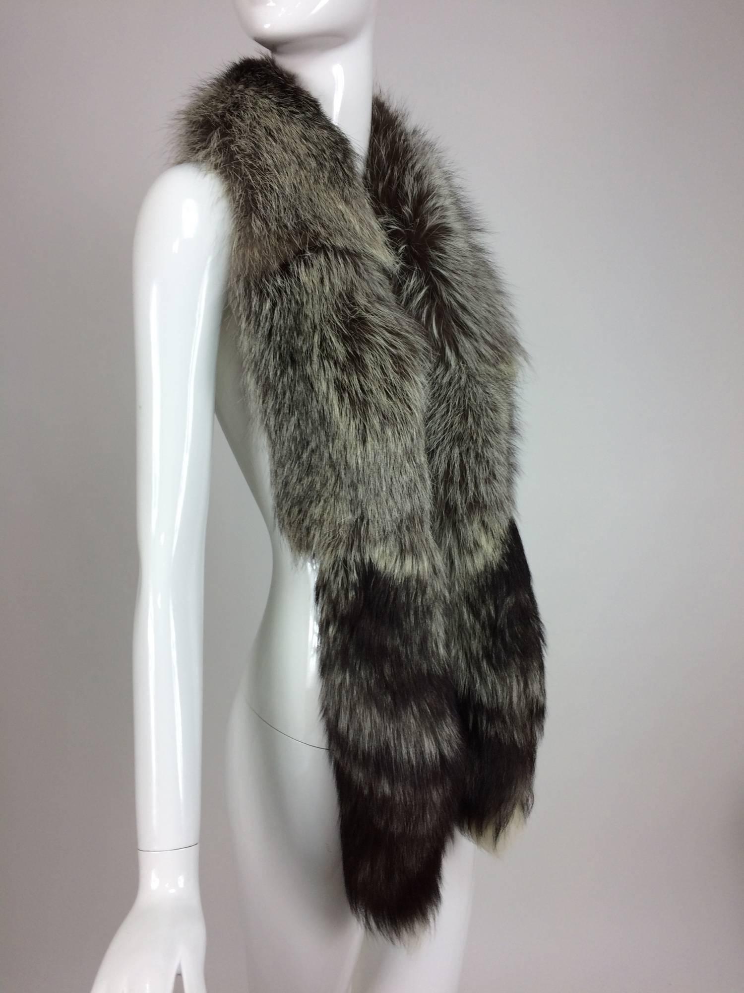 Beautiful silver fox long scarf with tails at each end...Full warm silvery fur...Lined in black velvet...1960s

In excellent wearable condition... All our clothing is dry cleaned and inspected for condition and is ready to wear...Any condition