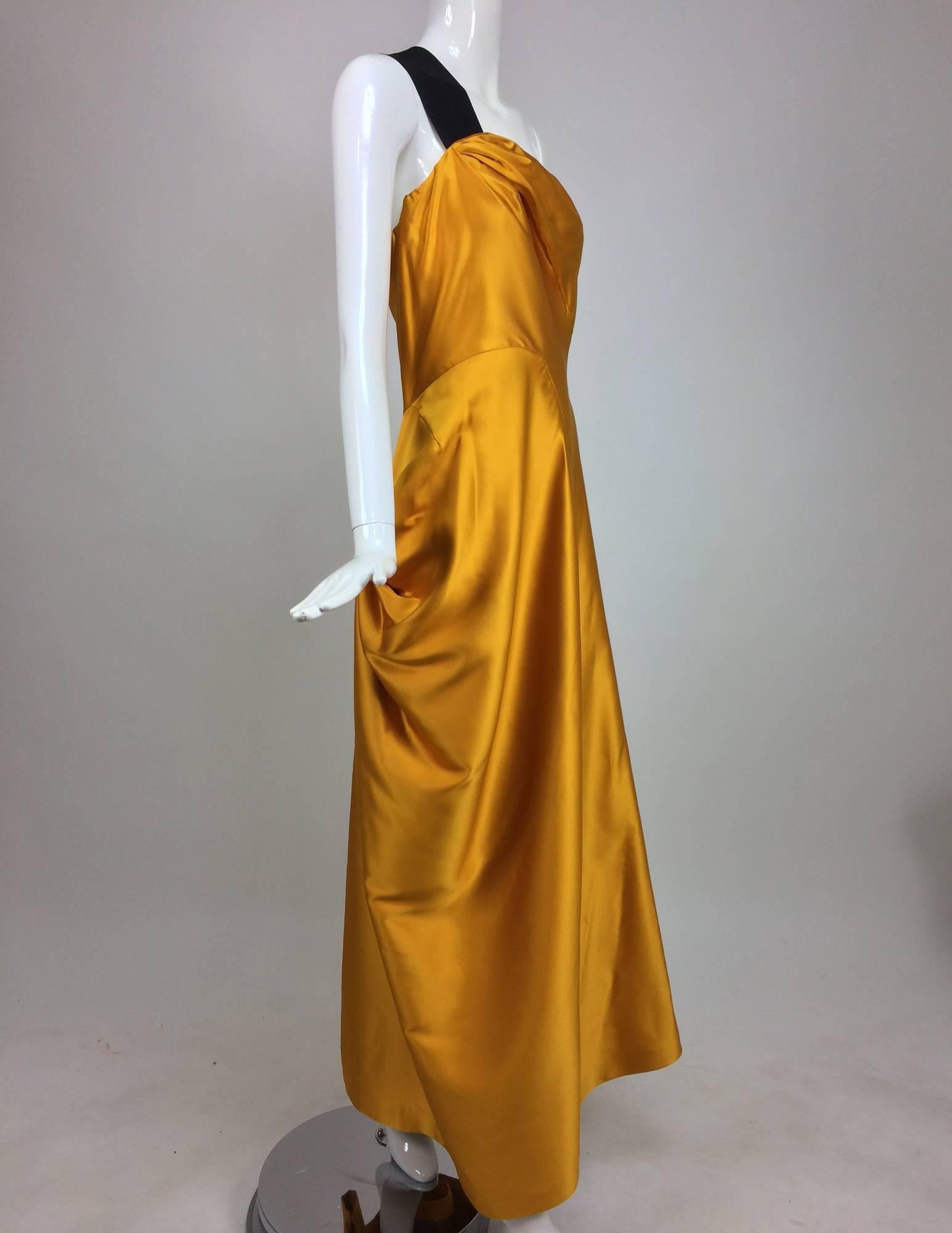 Dries Van Noten saffron silk one shoulder evening gown SS 2009...Beautiful saffron silk satin gown with a single wide black silk ribbon shoulder strap...The dress bodice is draped on one side...Seamed waist with side drape on one side and open