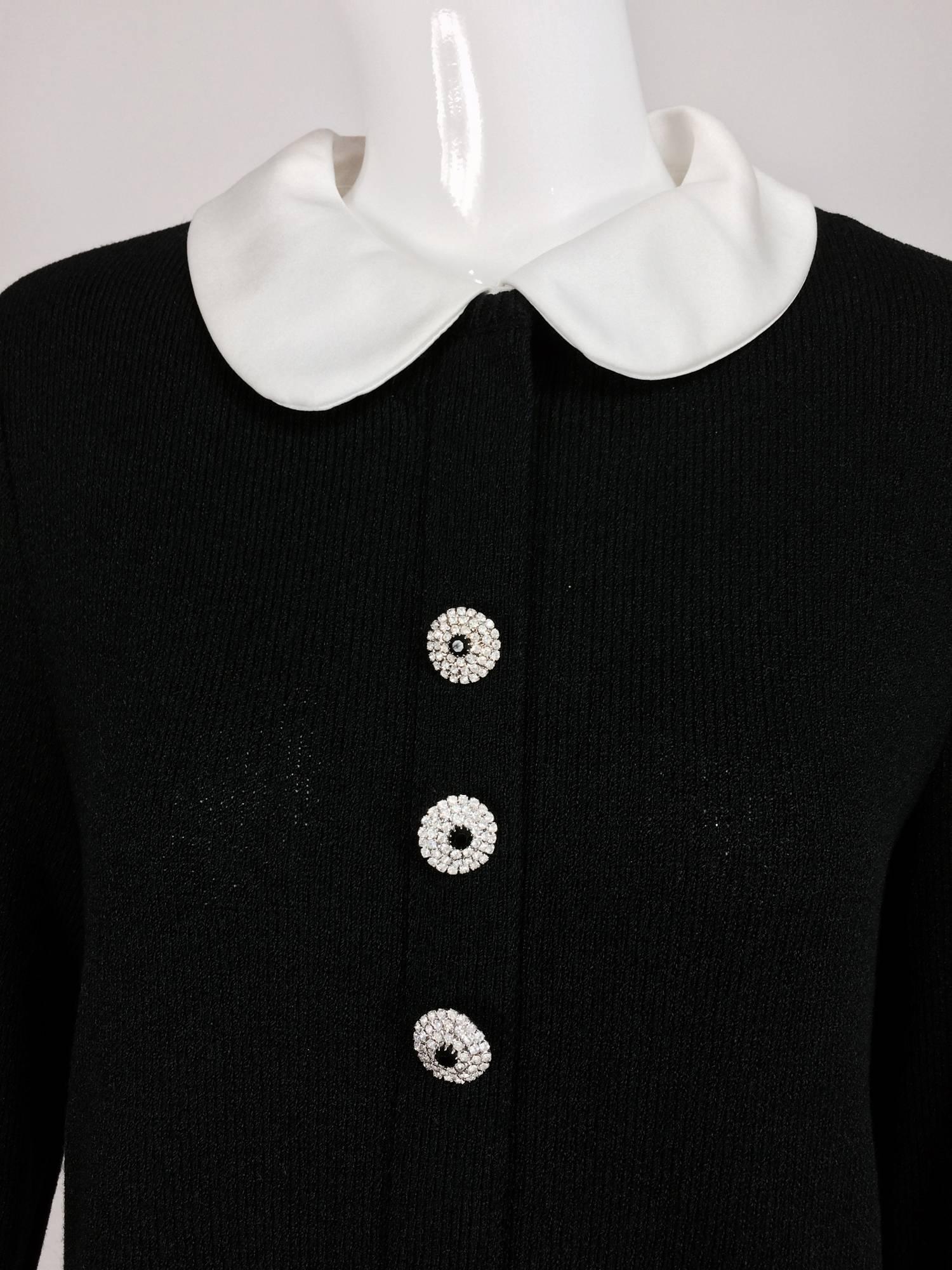 Adolfo black knit A line dress with white satin collar & cuffs 1970s...A line dress with a placket front that closes with rhinestone buttons, white satin button on collar (it's removable)...Long sleeves with white satin cuffs and rhinestone buttons