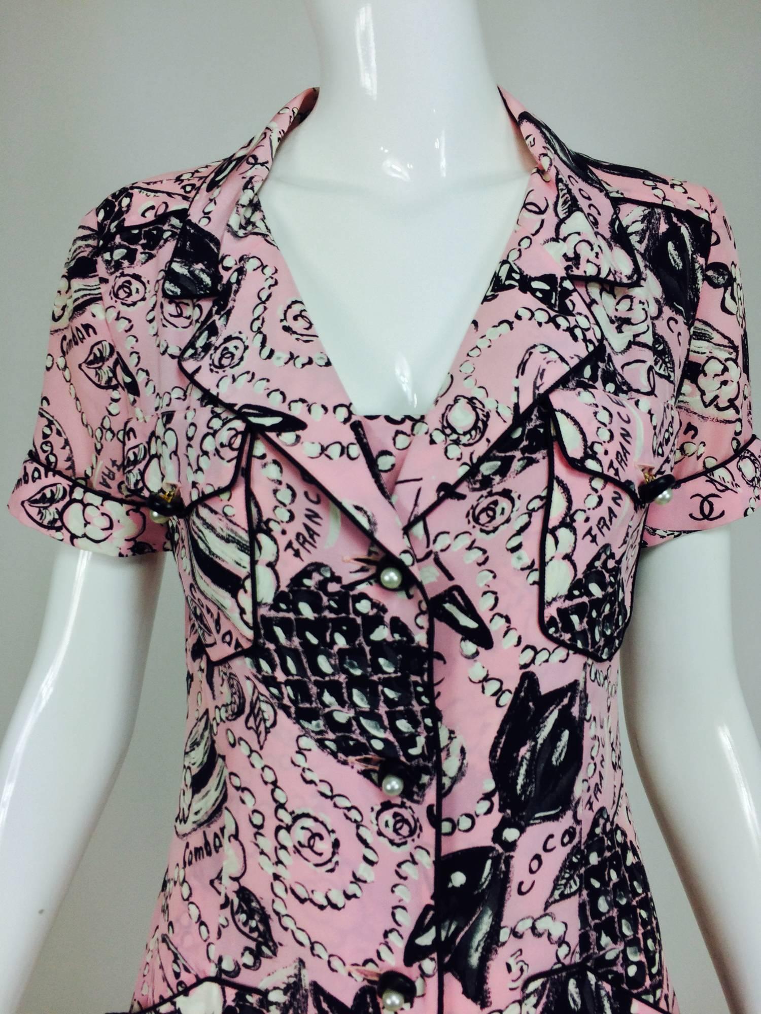 Chanel rare Claudia Schiffer runway worn Coco print dress pink silk 1993...1940s influenced, button front dress with short sleeves that have turn back cuffs...Front and back yoke...Two flap front button through chest pockets...The dress has a
