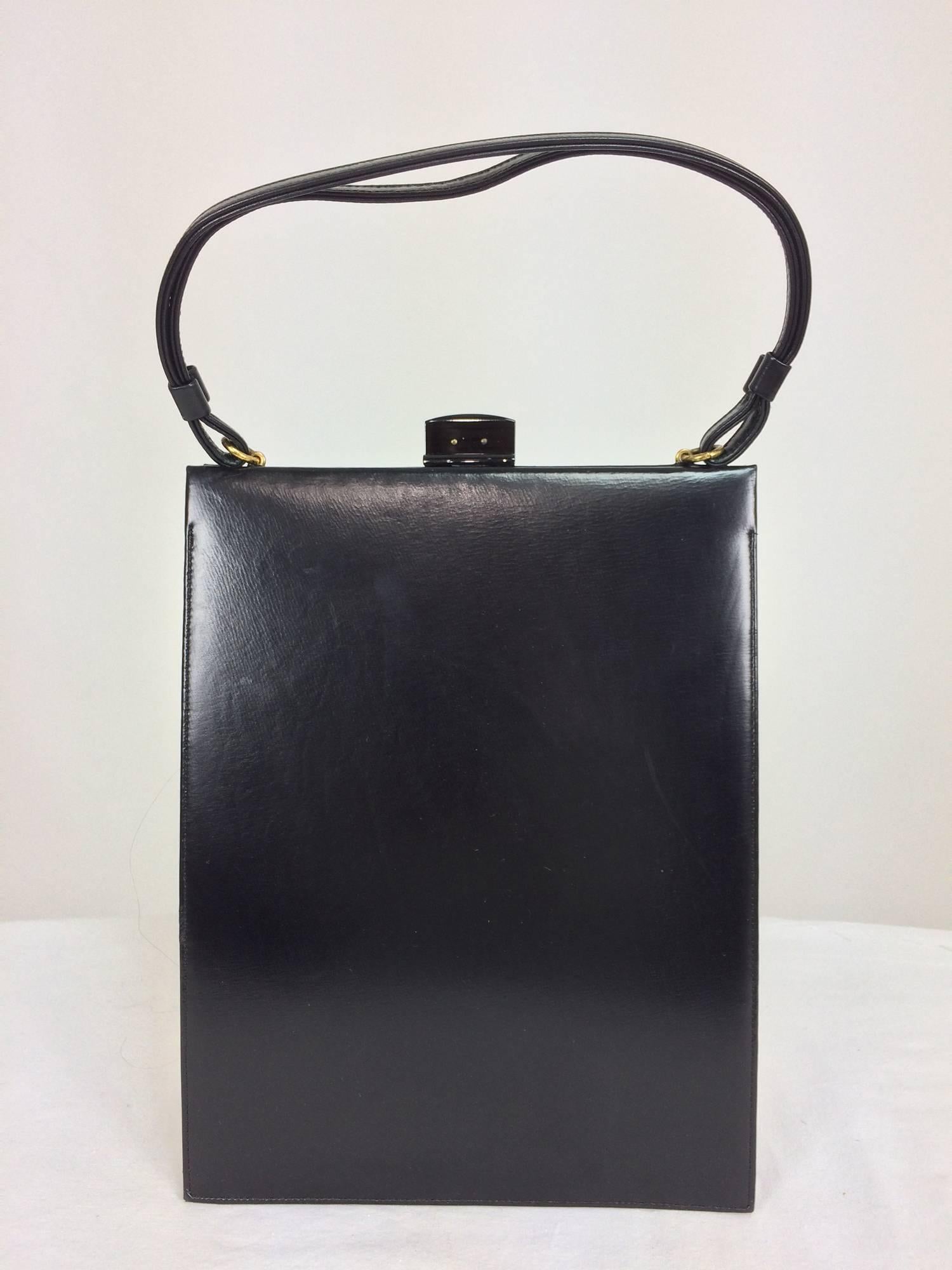 Bienen-Davis glazed black calf tall and narrow handbag 1950s...Glazed black calf with a gold crest and Bakelite clasp closure...The bag is 7 1/2