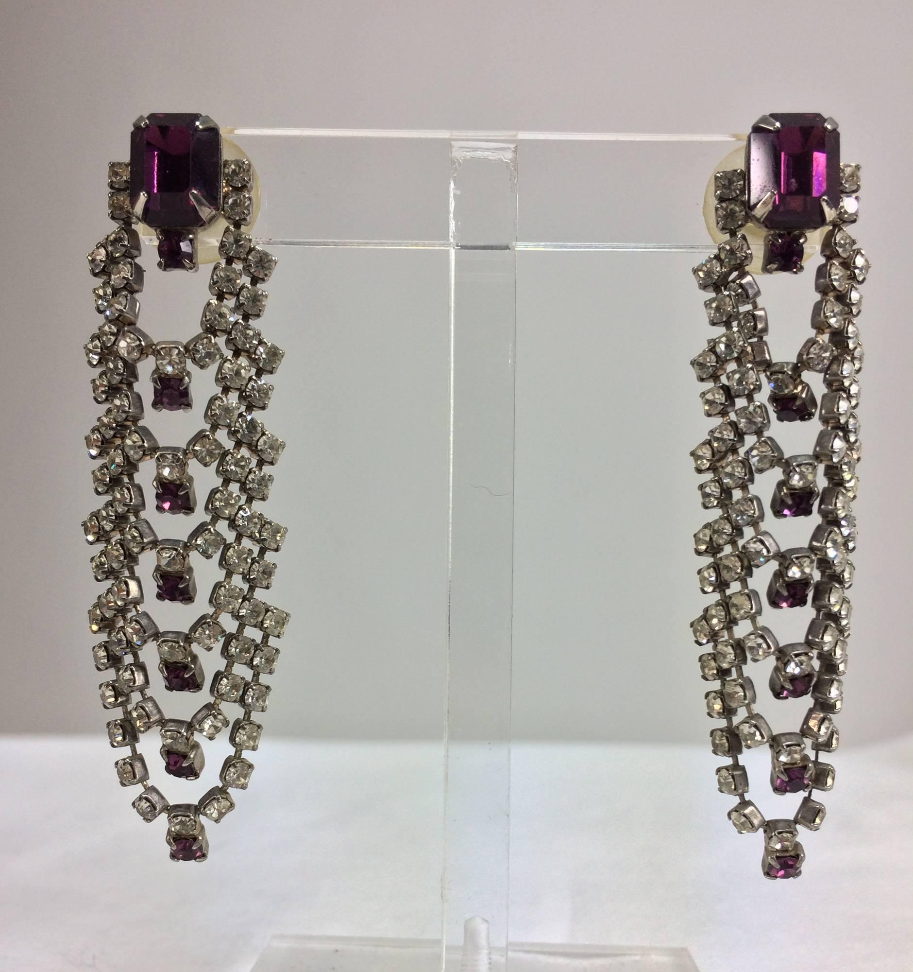 Faux Amethyst and rhinestone draped cascade pierced earrings 1960s...The faux amethyst at the top is an emerald cut, below are draped swags of crystal  rhinestones each centered with a single amethyst...These are for pierced earrings.
Approx. 2