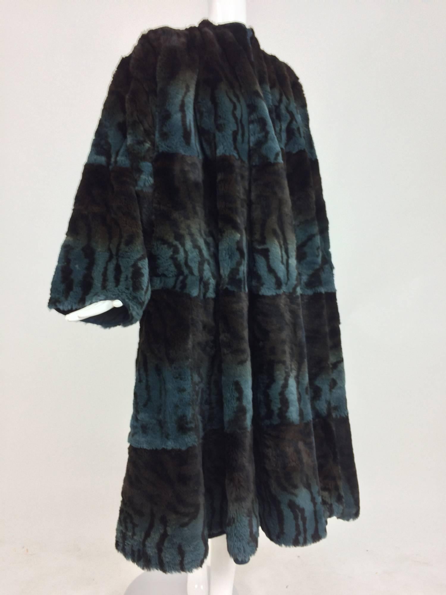 Gerard Babin Paris reversible stenciled tiger stripe lapin fur & black poplin and suede coat 1980s...Swing coat from the 1980s, it is very full from the underarm to the hem...Jewel neckline with long full sleeves...It can be worn with the fur side