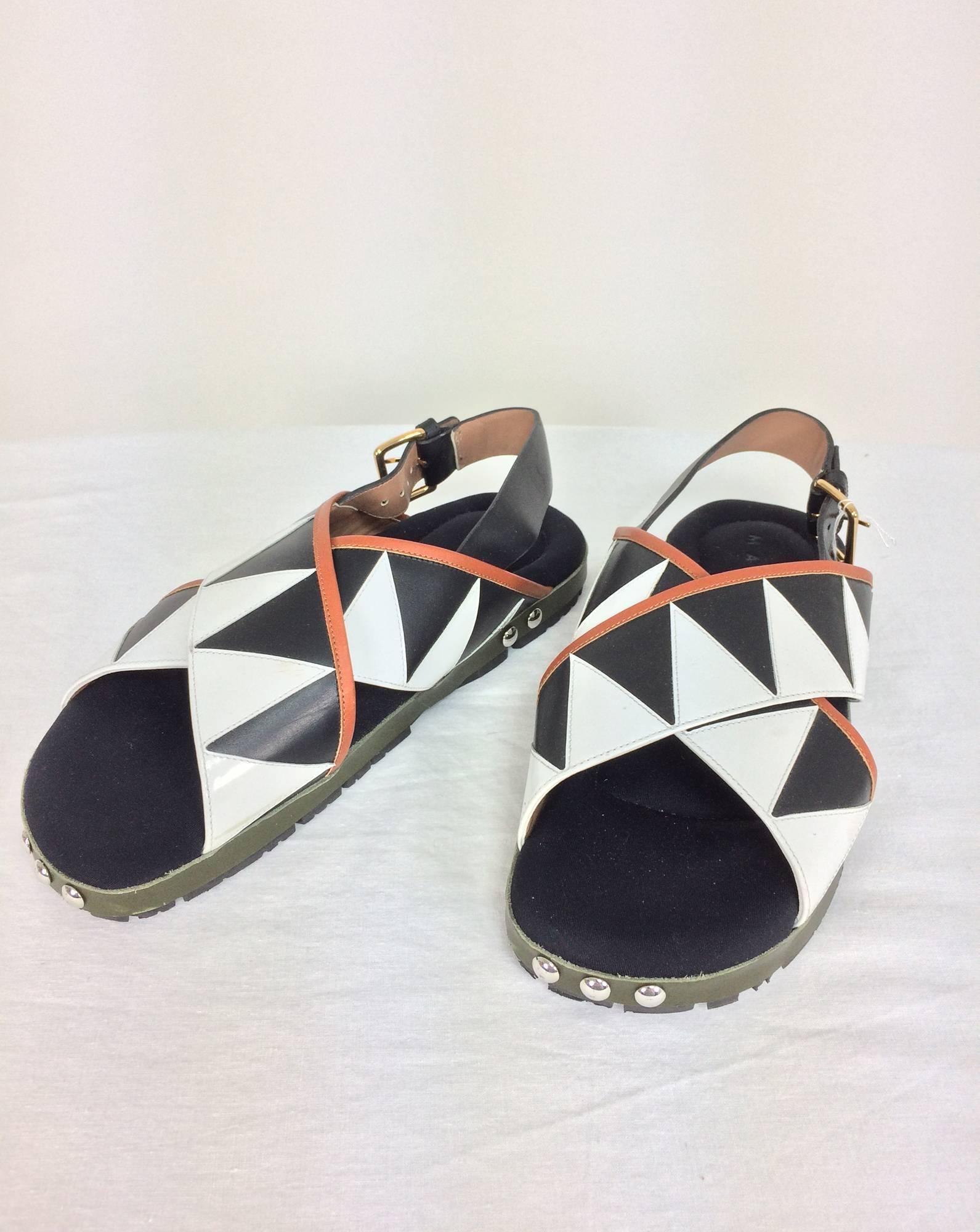 Marni geometric leather criss cross sandals 39M...White patent leather with black leather...Coral leather trim...Chunky rubber soles...Leather buckle straps...Silver studs...In Excellent pre owned condition.