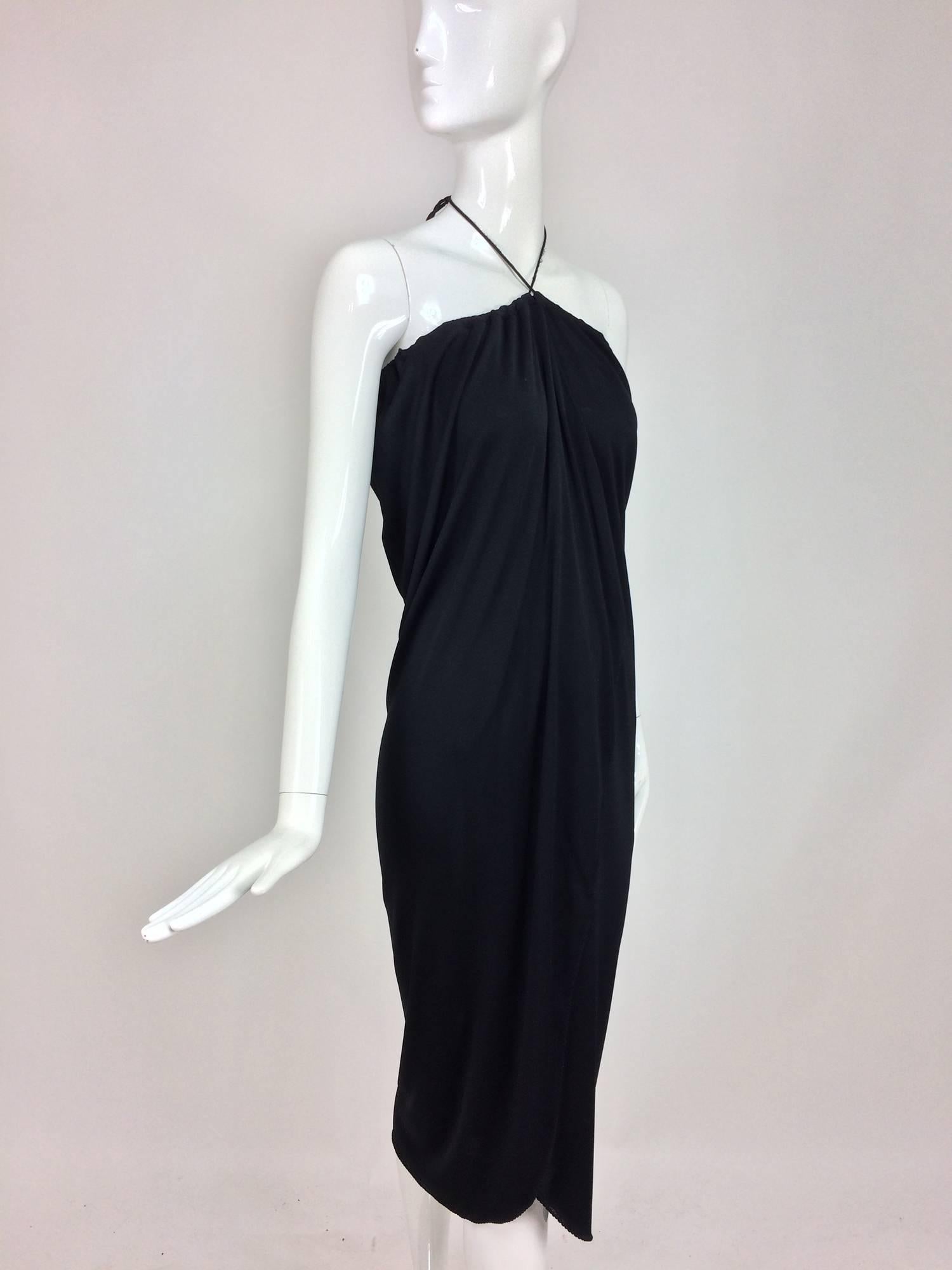 Stephen Burrows black jersey halter neck tulip hem dress 1970s...Silky rayon jersey with Burrows signature overcast facings....Pull on dress has a single narrow neck tie, that gathers the fabric ac the dress top...Wrap front forms a tulip hem...Fits