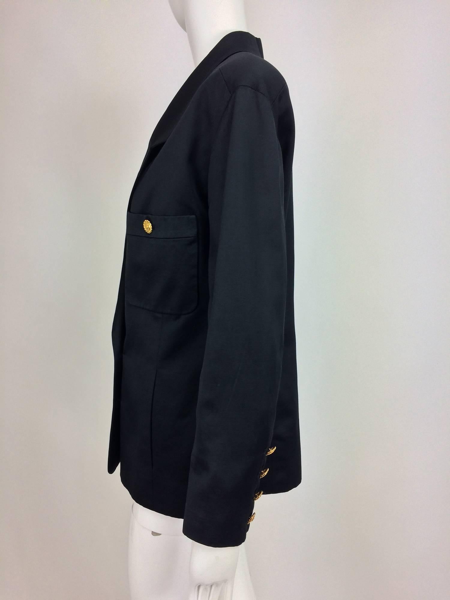Chanel black silk military style pea coat/jacket...Double breasted with gold Chanel buttons...Patch breast pockets with gold Chanel buttons and vertical front seam hand warmer pockets at the lower front...Hip length with slight waist shaping...4