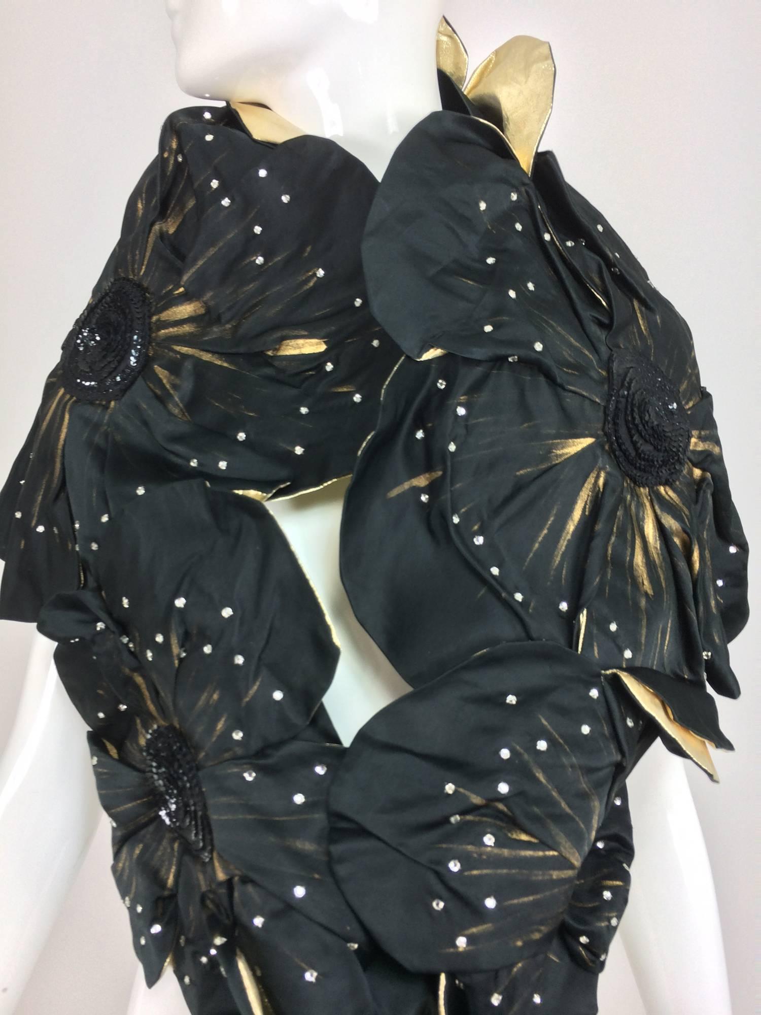 Hand painted black silk taffeta and gold lame floral fantasy evening wrap from the 1980s...Five large flowers each hand painted on black silk taffeta and set with crystal rhinestones, the centers are rounds of black sequins, backed with gold tissue