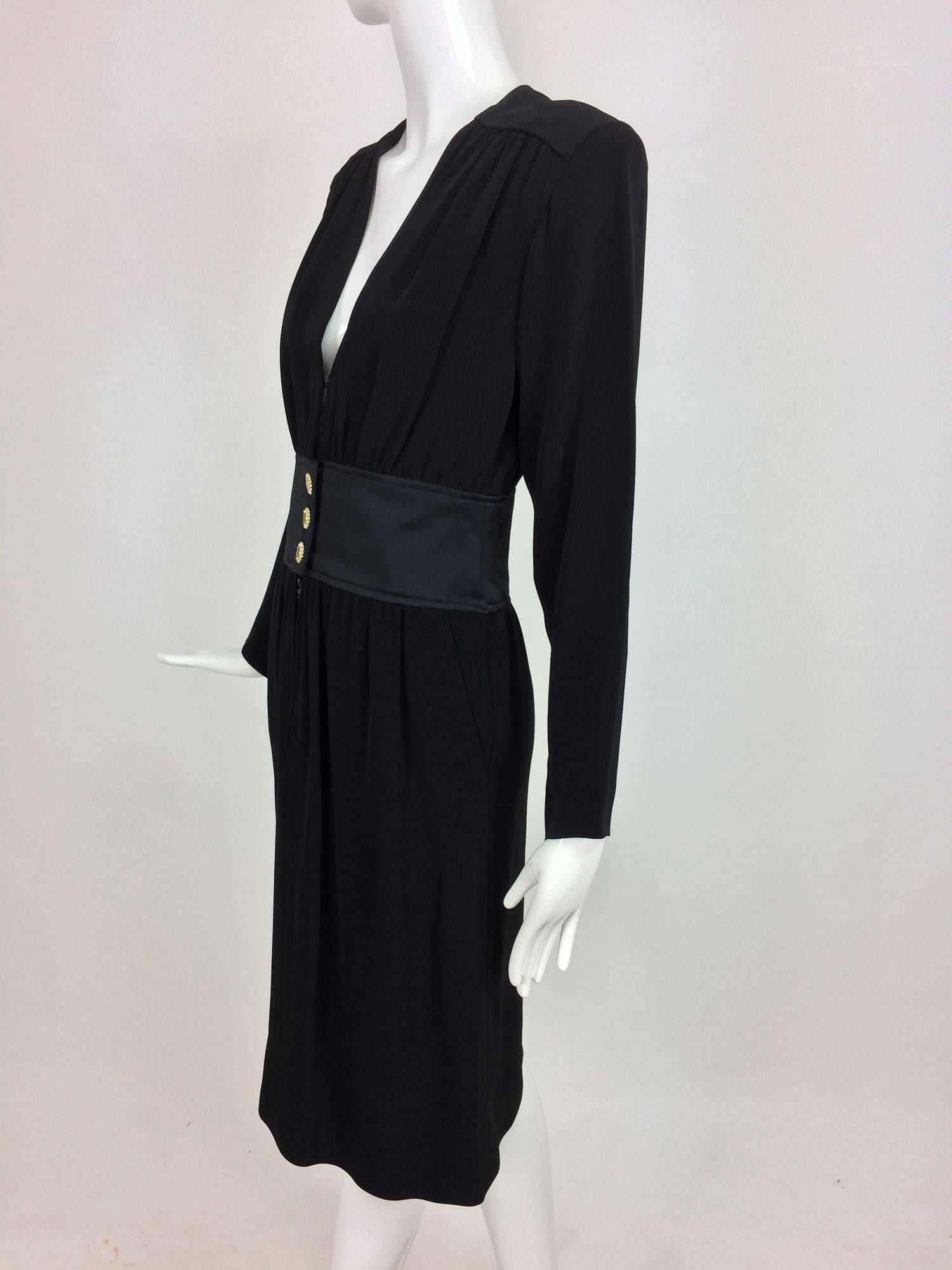 Vintage Yves St Laurent black crepe and satin cocktail dress 1990s...This chic classic dress has a V neckline front, long sleeves with padded shoulders, jewel buttons  at the shaped black satin waist...The skirt is slightly gathered and falls just