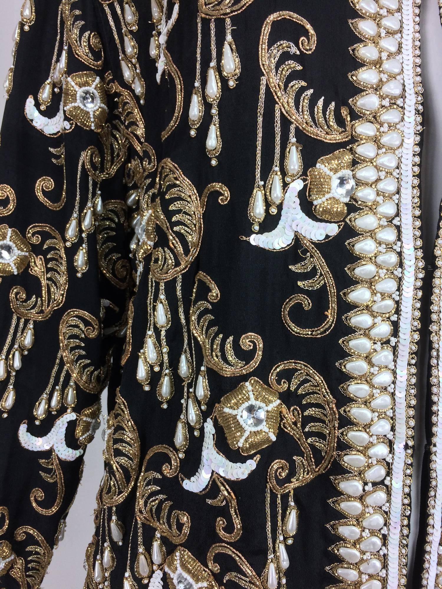 Vintage heavily beaded and embroidered black silk jacket 1990s marked size Large...Open front, jewel neck jacket with long sleeves...Embroidered with gold cord...Covered with pearls, gold beads, white and gold sequins and large rhinestones all done
