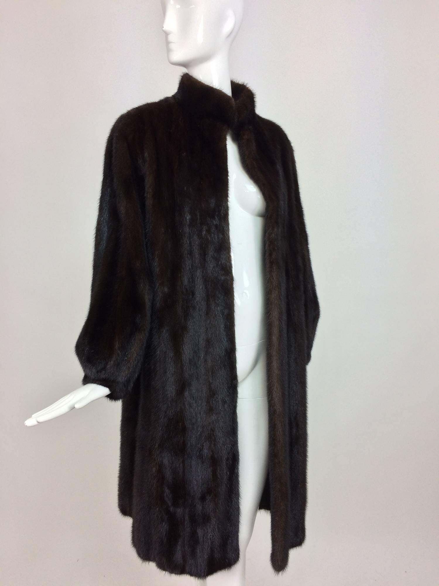 Full length lustrous dark mink coat with gathered cuffs from the 1960s...A beautiful coat, with a stand up collar, long semi full sleeves with banded cuffs and on seam front pockets...There are no closures to this coat and no evidence there were