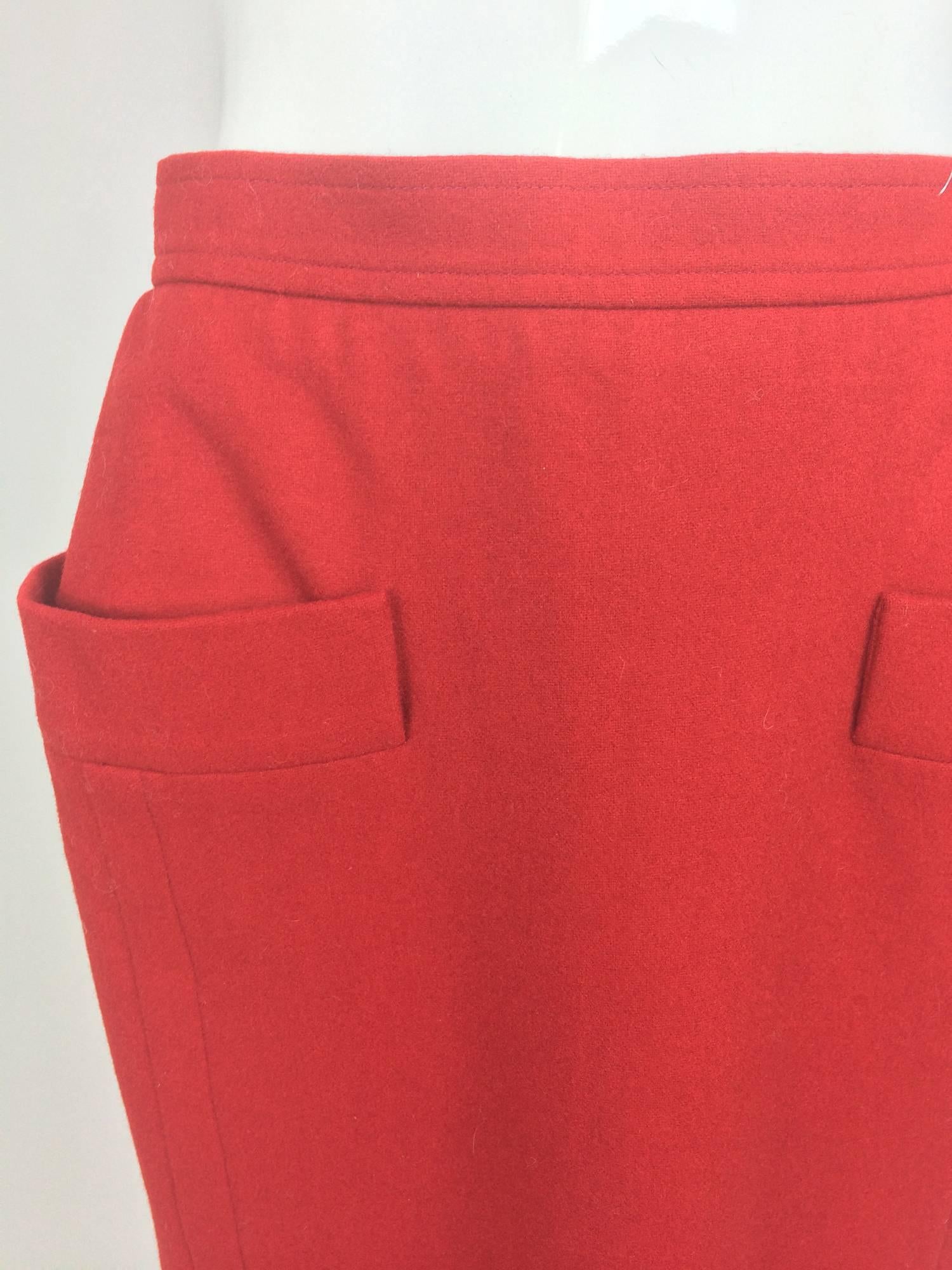 Yves Saint Laurent fine brick red wool straight skirt with hip front pockets from the 1980s...Banded waist skirt closes at the side with a zipper and button at the waist...Four top stitched seams two at the front and two at the back...Fully lined
In