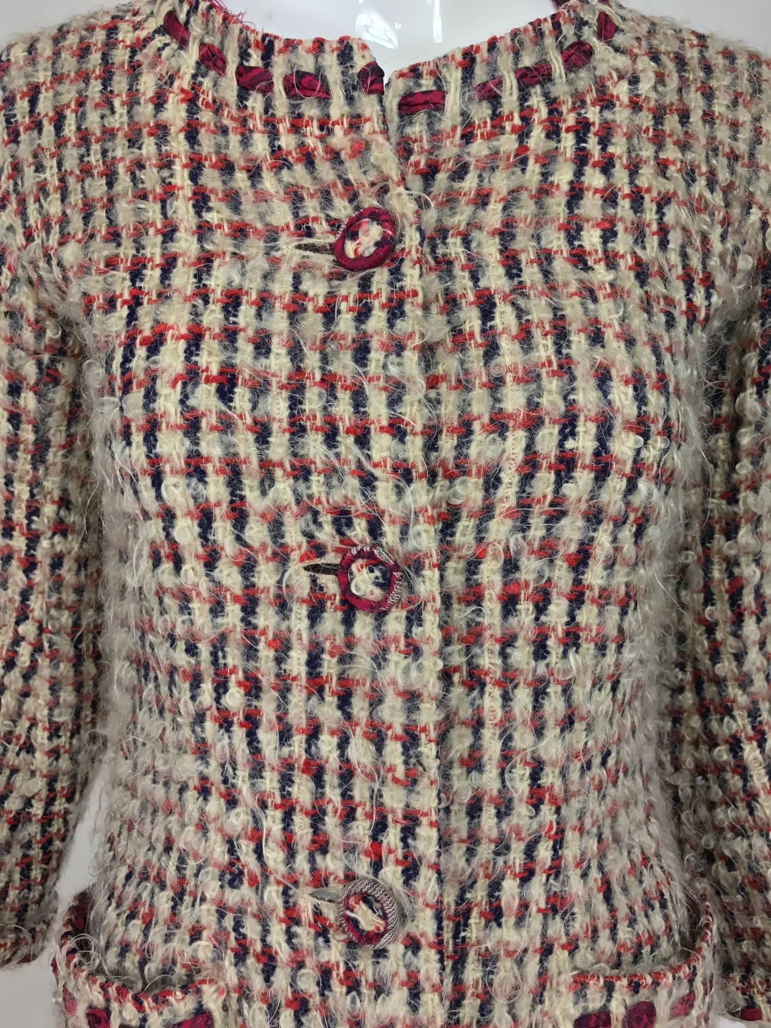 Chanel Haute Couture mohair wool coat from the early 1960s. Woven red, cream and blue check mohair and wool blend coat has silk ribbon run trims at the collar, cuffs and pocket edges, the silk ribbon matches the lining of the coat, which coordinates