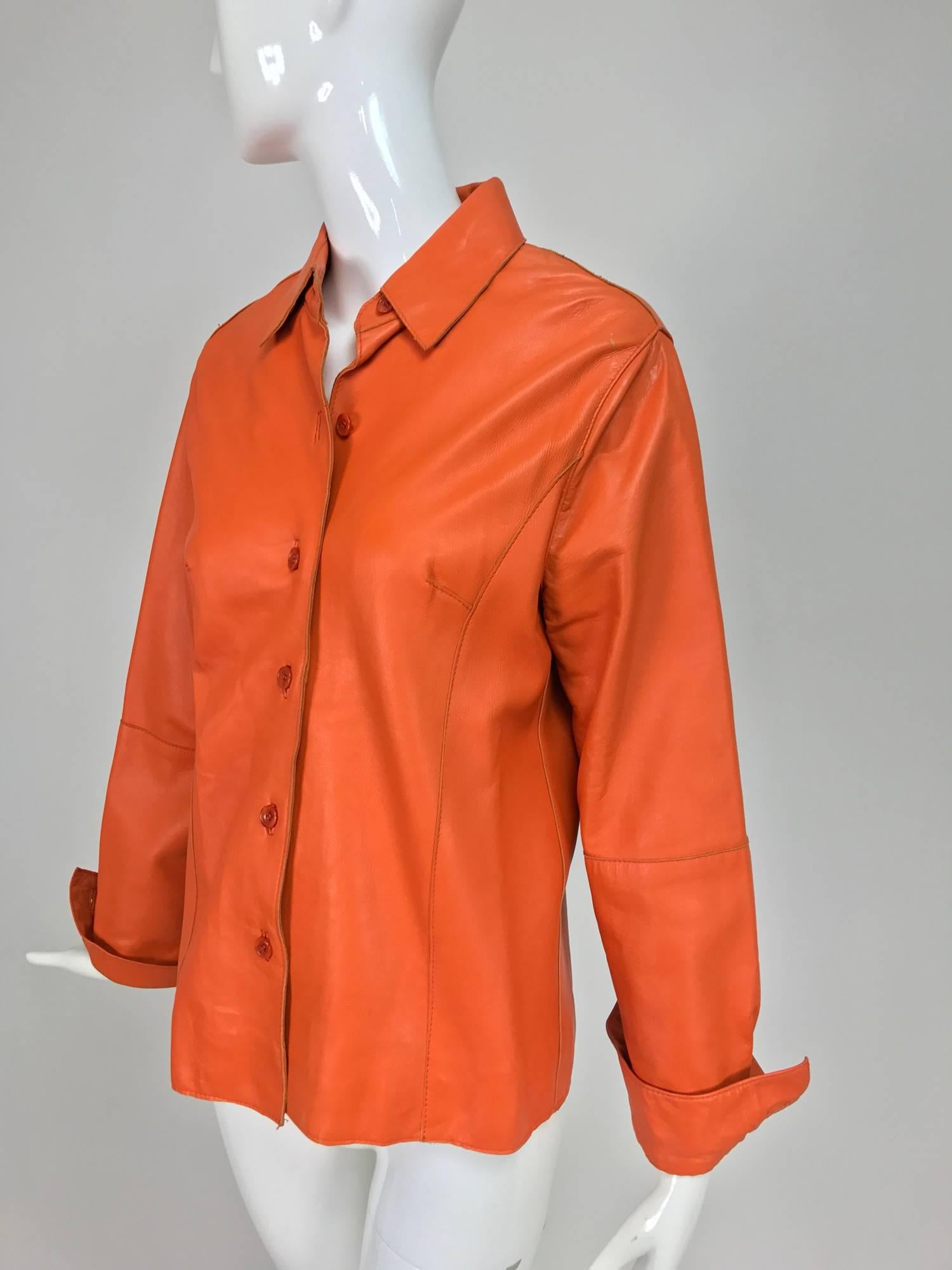 Vintage orange leather button front shirt jacket from the 1970s...Shirt style jacket with button cuff long sleeves, darted bust, button front...soft leather, fully lined in bright orange satin...A couple of very minor wear marks...Marked size medium