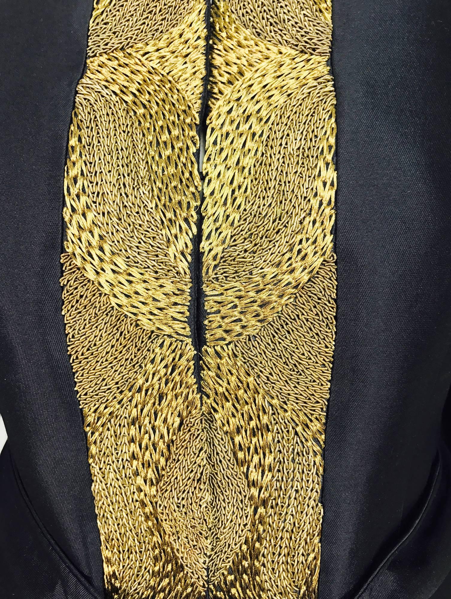 This amazing jacket from Rena Lange is black wool and silk, but feels like silk...Heavy gold cord embroidery is a real eyecatcher...Hidden button and loop closure at the front and each side facing is embroidered...Round neckline...Long sleeves with