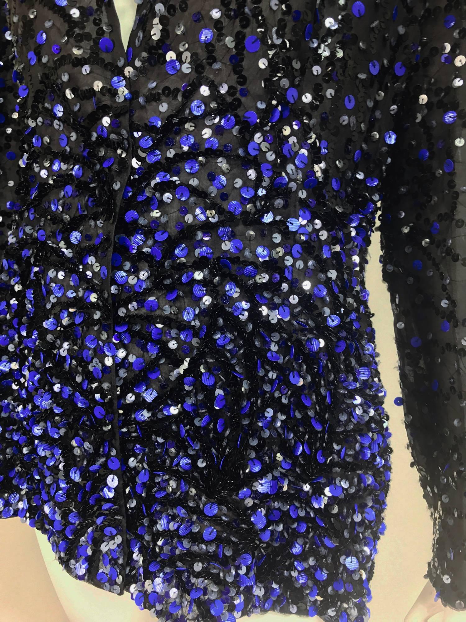 Glittery black and blue sequins embroidered on a black silk organza jacket...Long sleeves narrow band collar...Jacket is open at the front...Fully lined in silk organza...Shaped at the waist and fits over the hips...Unworn with tags...Marked size 10