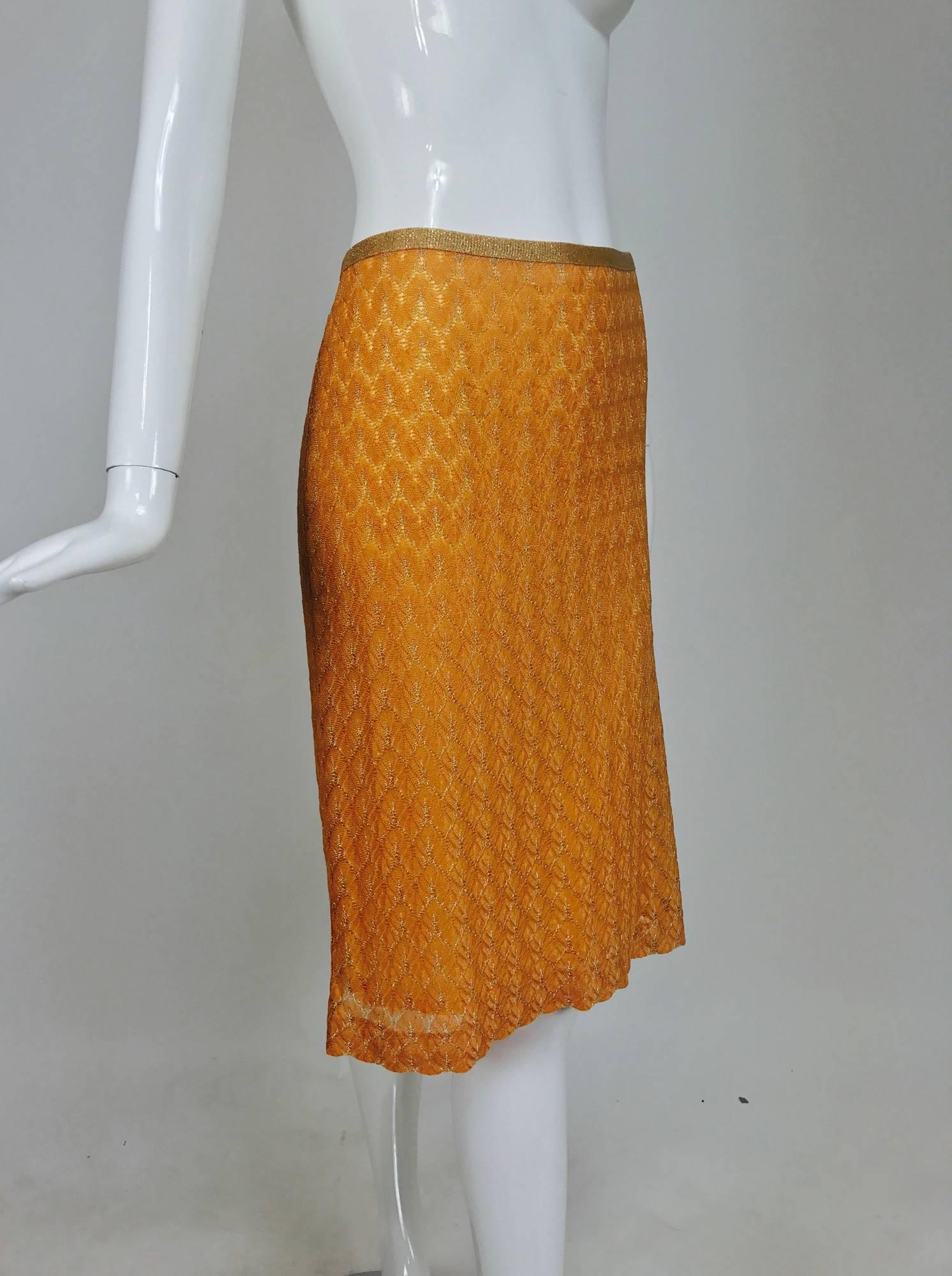 Missoni coral and gold metallic knit straight skirt...Gold metallic knit waist band...Fully lined...Center back kick pleat...Closes with a zipper and hook and eye at the back...Unworn new without tags...Marked size 44, measurements below.

In