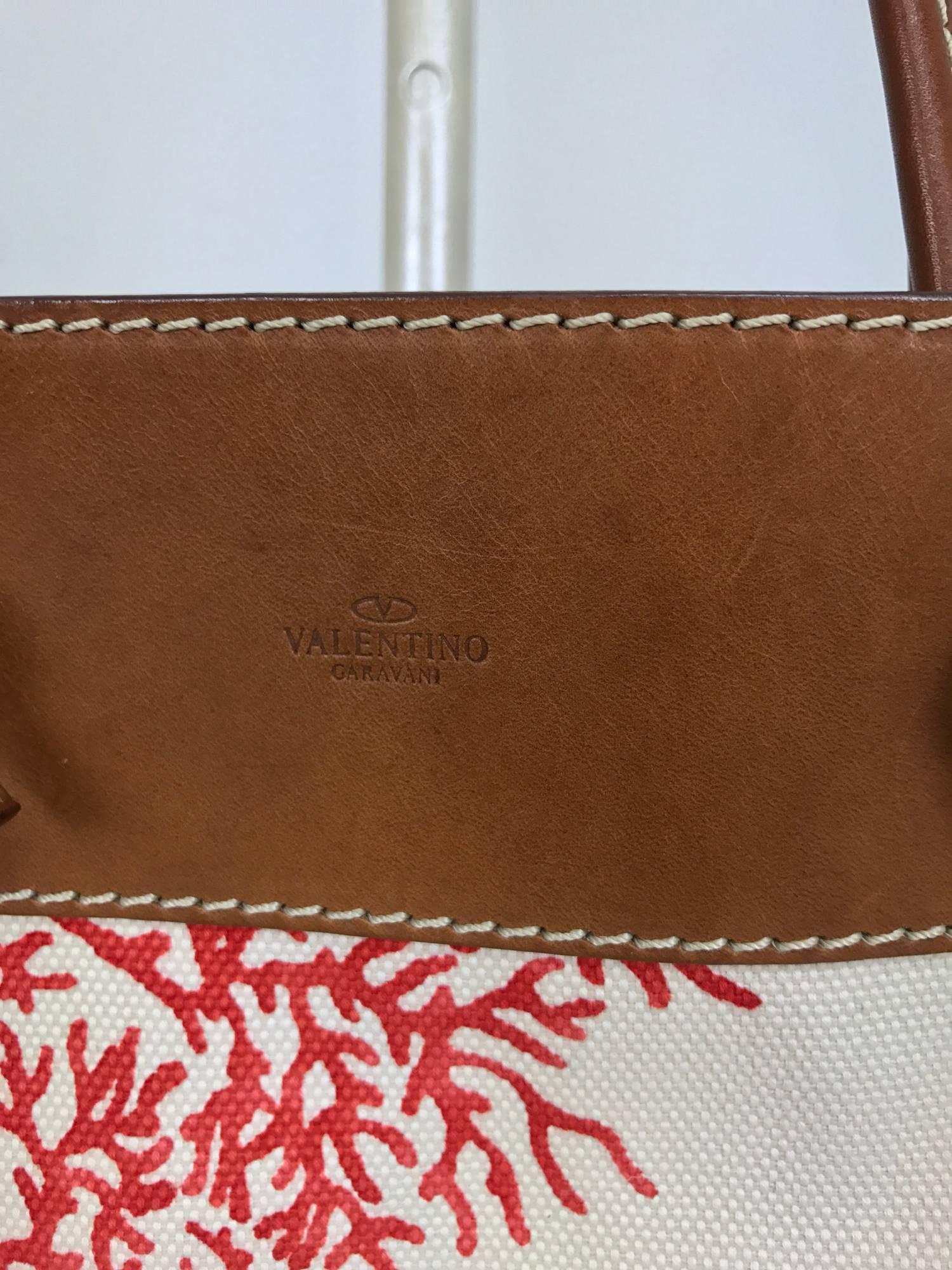 Valentino leather trimmed painted coral canvas tote bag...Beautiful bag with wide cognac saddle leather band and handles at the bag top and sides with cream top stitching...Painted branch coral on off white canvas...The bag is lined in pale coral