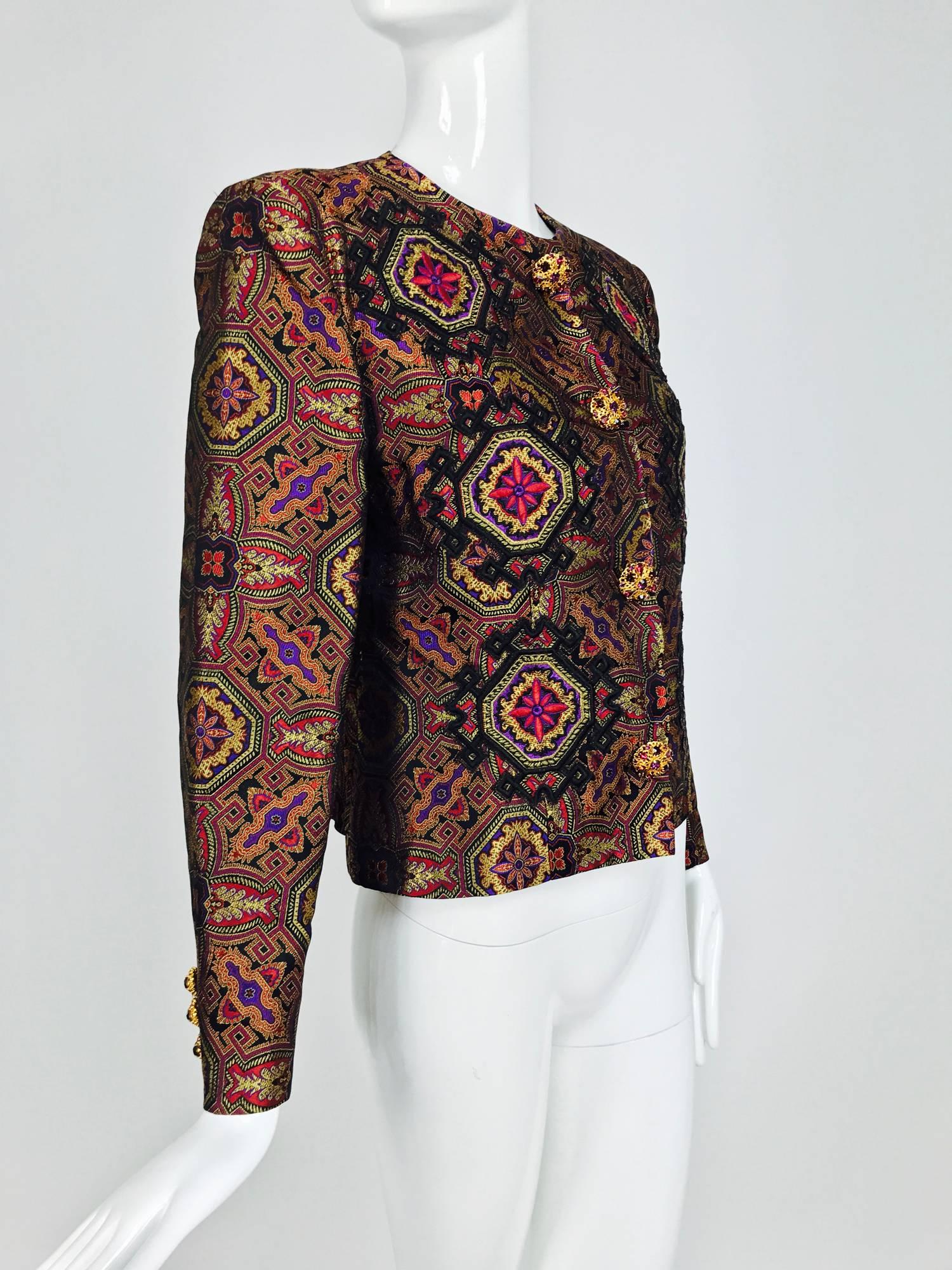 Christian LaCroix silky jewel tone brocade jacket with appliques on the front and a large metallic embroidered applique on the back...Round neck jacket closes at the front with garnet coloured jeweled buttons, closes with hidden couture snaps, three