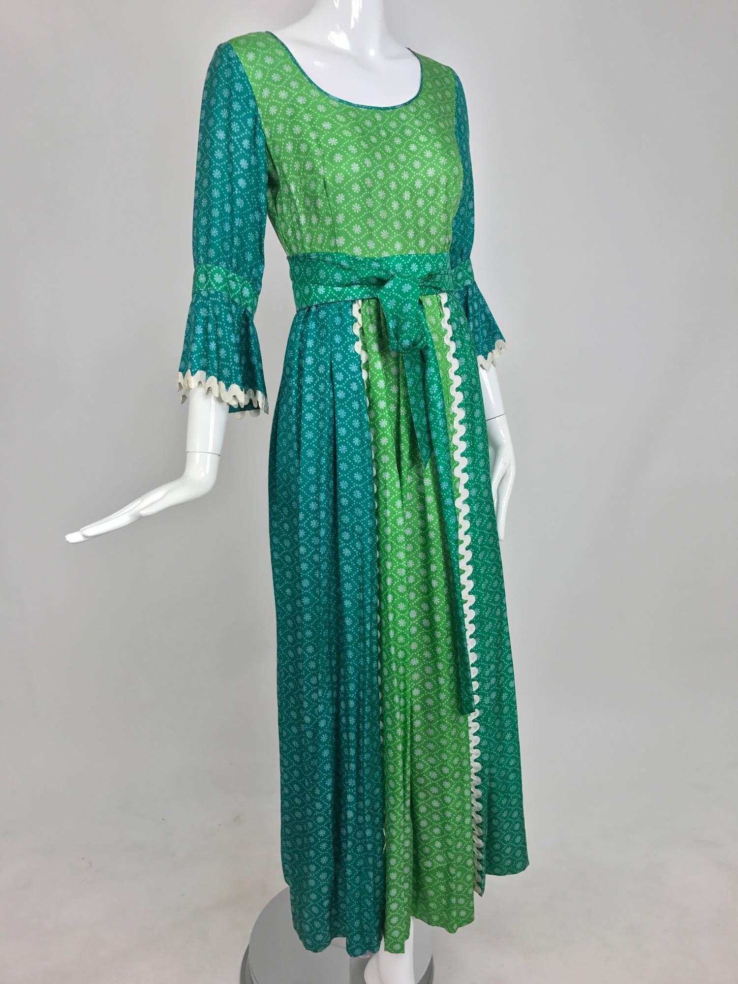 Vintage aqua and green silk print maxi dress with white trim 1970s...Labeled the Mirrors...Scoop neck fitted bodice with 3/4 length sleeves that have a band and ruffle below...The attached skirt is gathered at the waist and falls semi full to the