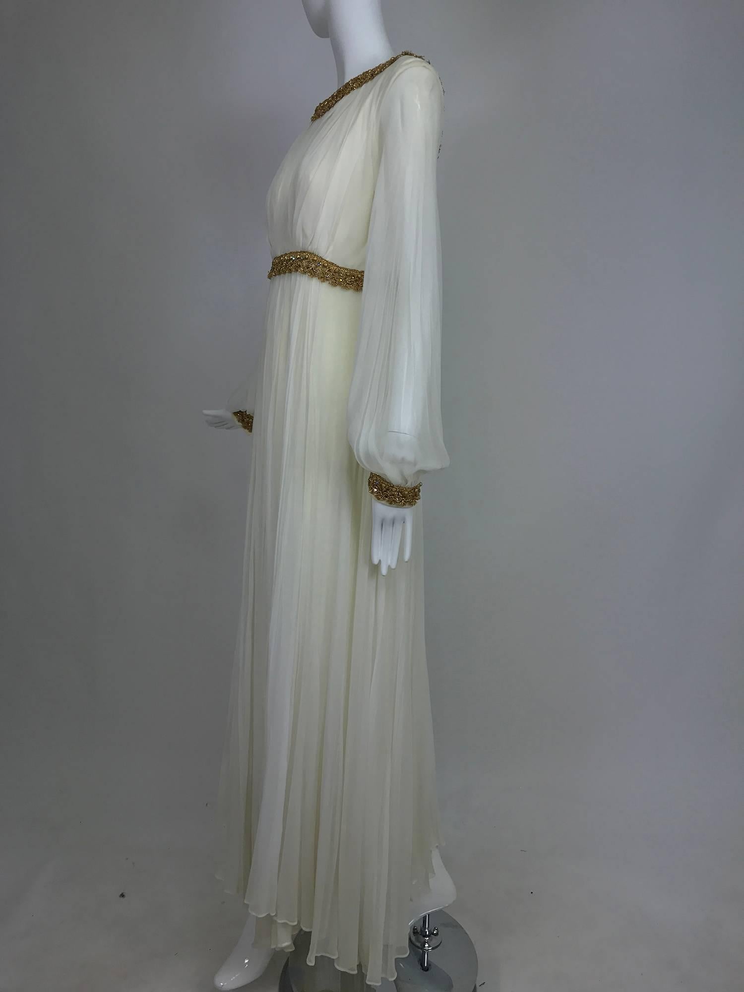 Vintage cream double layer silk chiffon maxi dress with gold rhinestone set braid trim from the 1970s...The chiffon drapes and flows, this is a very graceful dress and could definitely be worn as a wedding dress...Deep scoop neckline is trimmed in