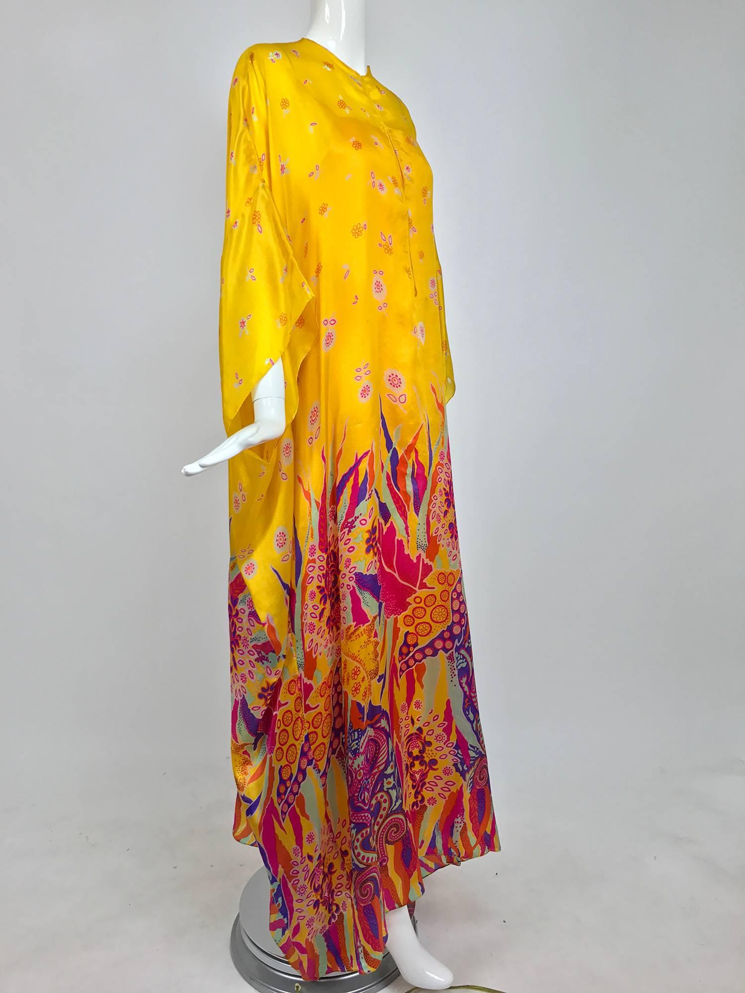 Amazing Oscar de la Renta 2pc caftan and crepe under dress from the 1970s...The caftan is an extravagant border print in vibrant colours the upper dress is done in a small print of coordinating colours on saffron, caftan of tissue silk...The loose