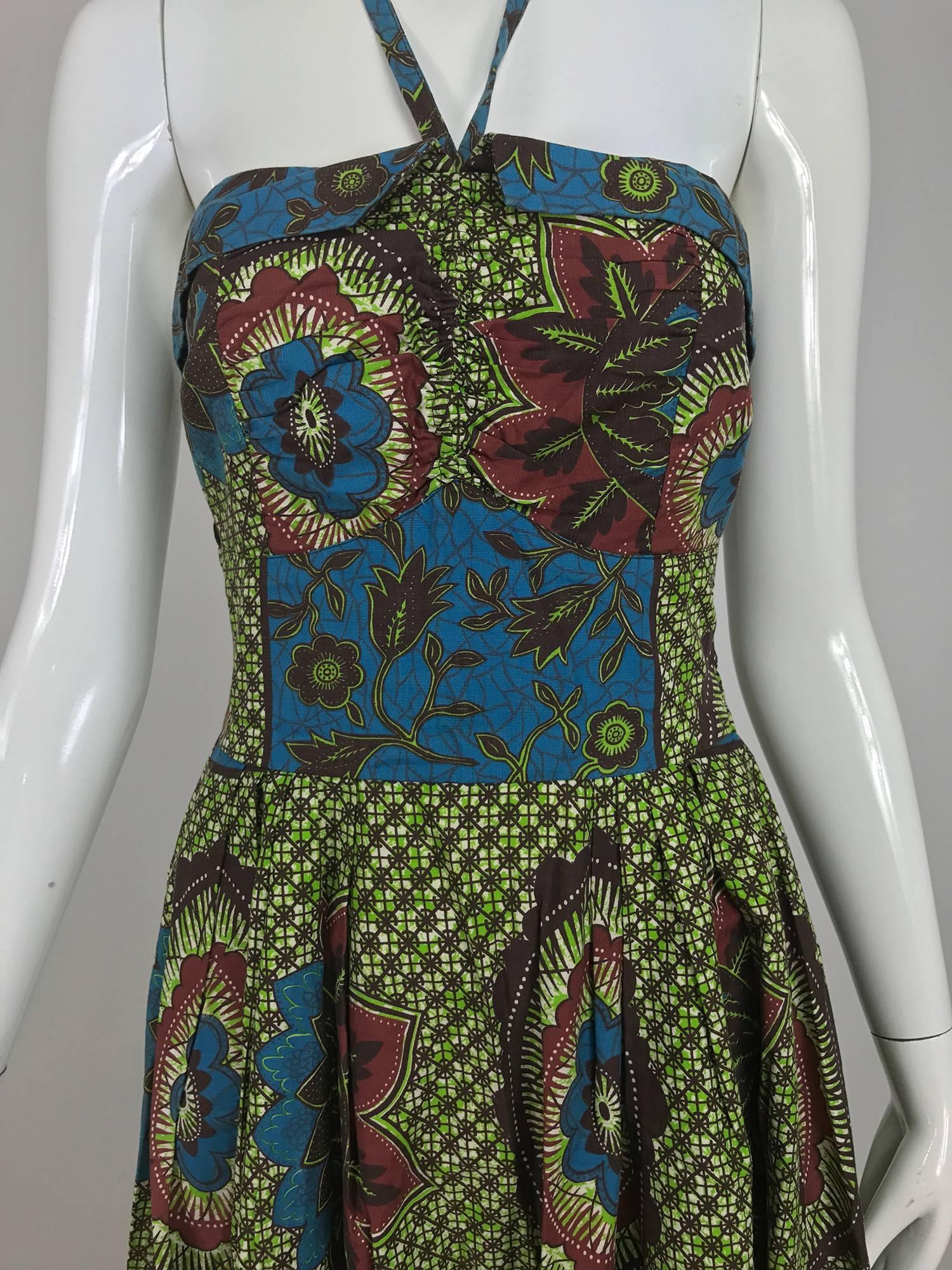 Vintage sun dress from Miss Hawaii made by world famous Kamehameha garment company. A beautiful cotton batik print dress can be worn strapless, but comes with the attached halter straps. The fitted bodice turns down at the bust top, the back is