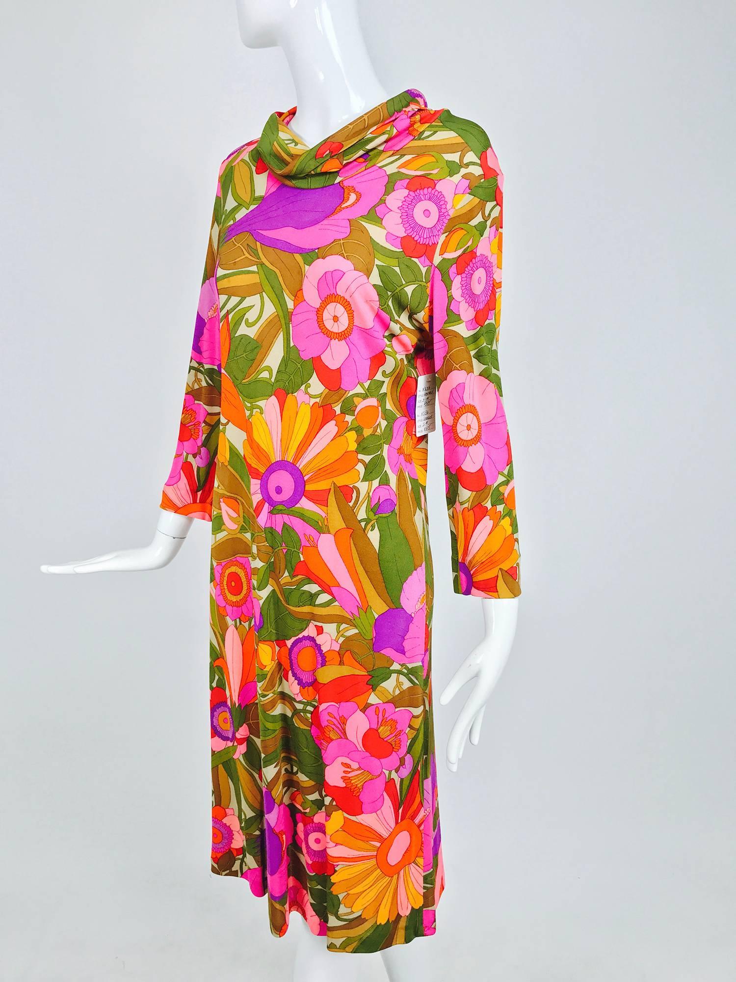 Silk jersey dress in a vibrant fantasy floral pattern...Pull on dress has a cowl neckline and long sleeves...Unlined...Inside tag and marked 4, there is no Leonard label...Fits a size Medium...

In excellent wearable condition... All our clothing is