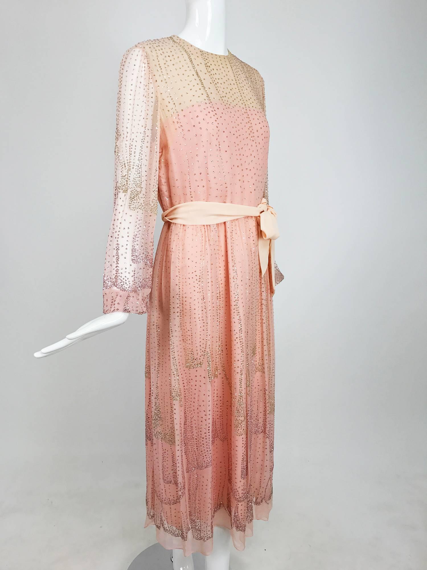 Beautiful soft pink silk chiffon dress from the 1970s, labeled Richilene...The fabric of the dress is decorated with silver and pink glitter done in a cascading design on the skirt and vertical icicles on the bodice and sleeves, there is some